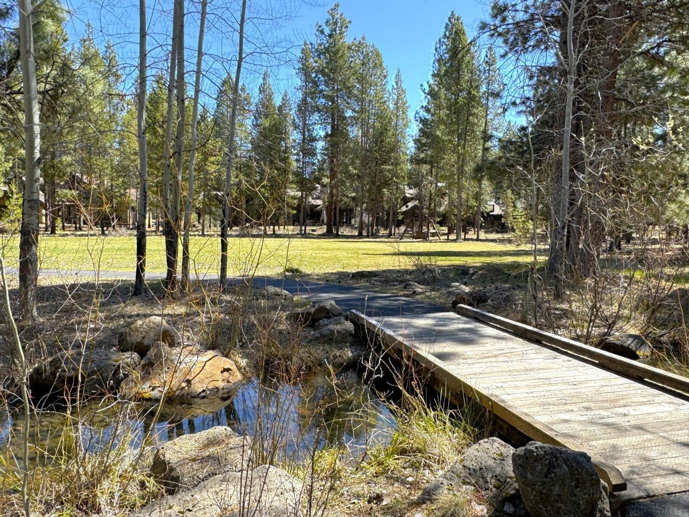 Lot 257 offers a rare opportunity to own property adjacent to the serene and beautifully maintained Sable Rock Park. This expansive green space, lined with towering Ponderosa pines, creates a picturesque setting ideal for family recreation—from casual soccer matches to impromptu games of baseball or frisbee. A charming walking path meanders through the park alongside a seasonal creek, connecting to two lush ponds at either end. It’s a perfect spot for morning bike rides, peaceful strolls, or unforgettable hide-and-seek adventures. Whether you're looking to build your dream home or invest in a highly desirable location, Lot 257 provides the natural beauty, tranquility, and recreation that make everyday living feel like a getaway.