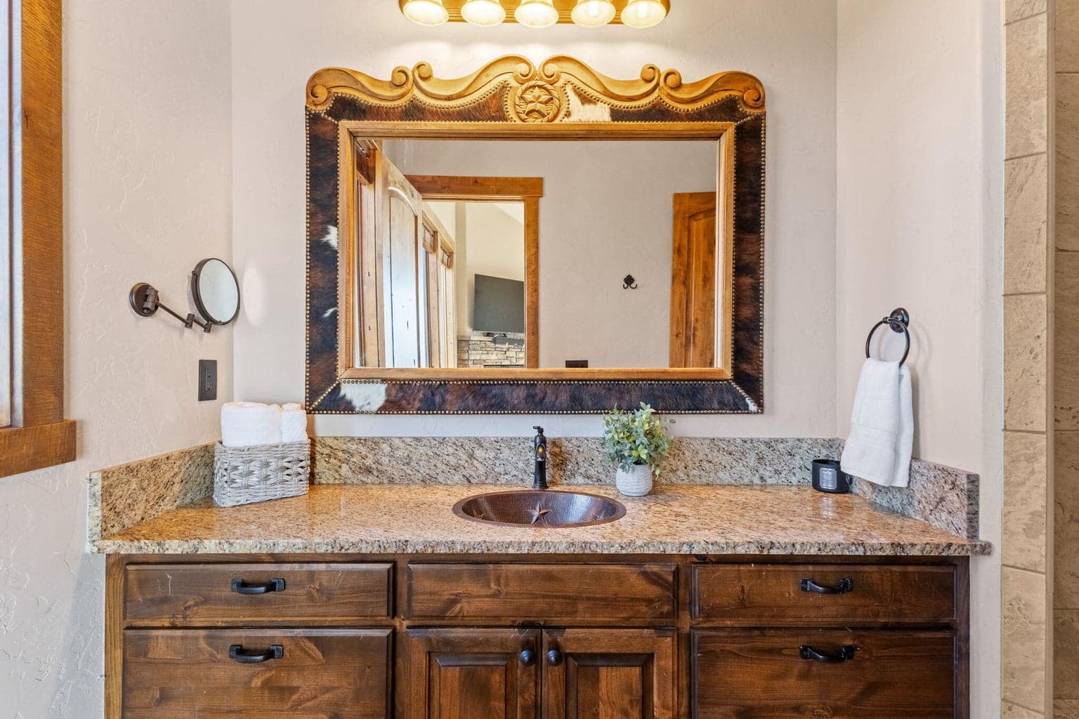 Custom cowhide mirror and granite counters.