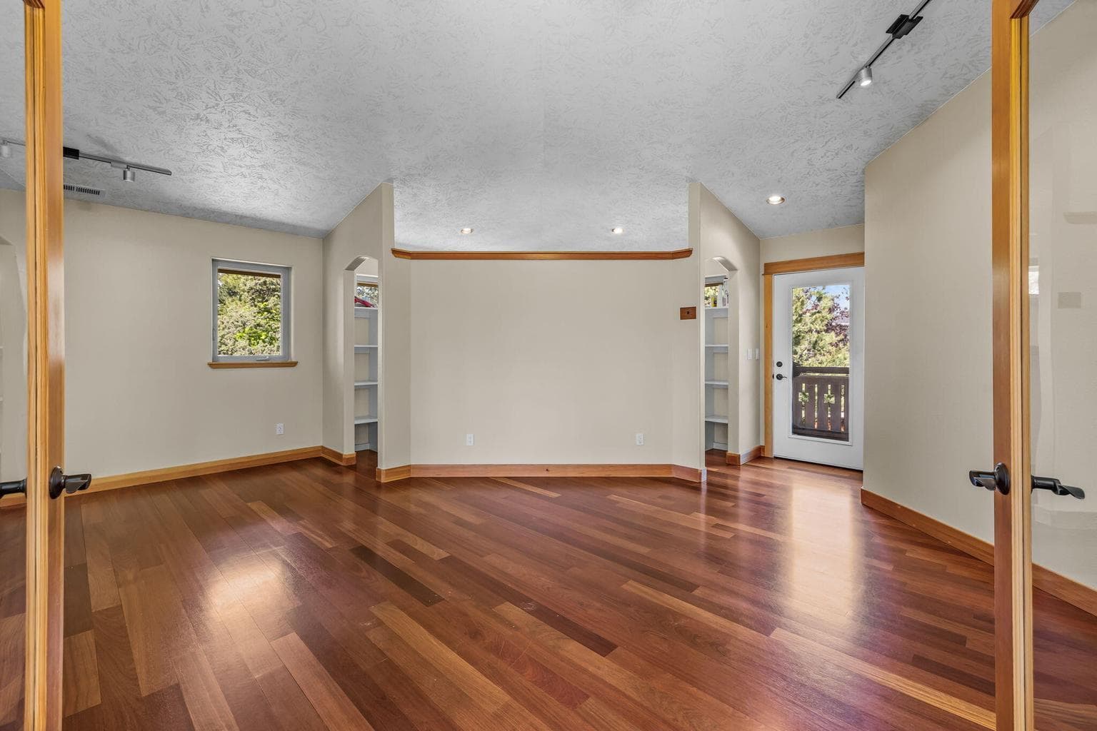 Primary Suite on upper level w/hardwood floors.