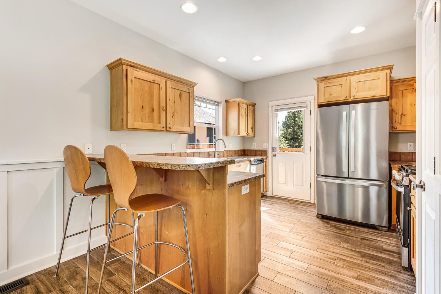 Kitchen with breakfast far and stainless steel appliances