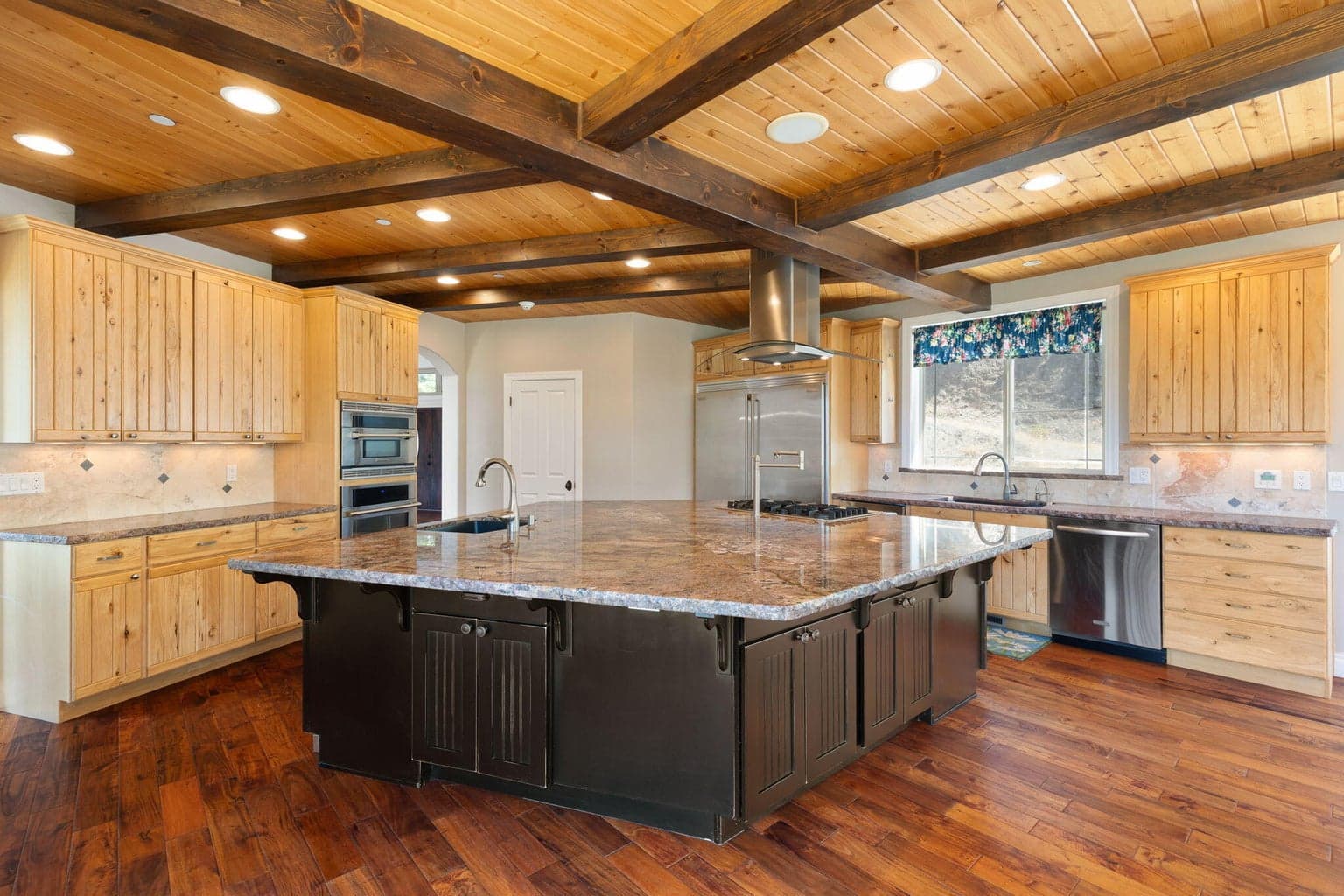 Chef Kitchen with huge island includes range, wet bar sink & built in ice maker