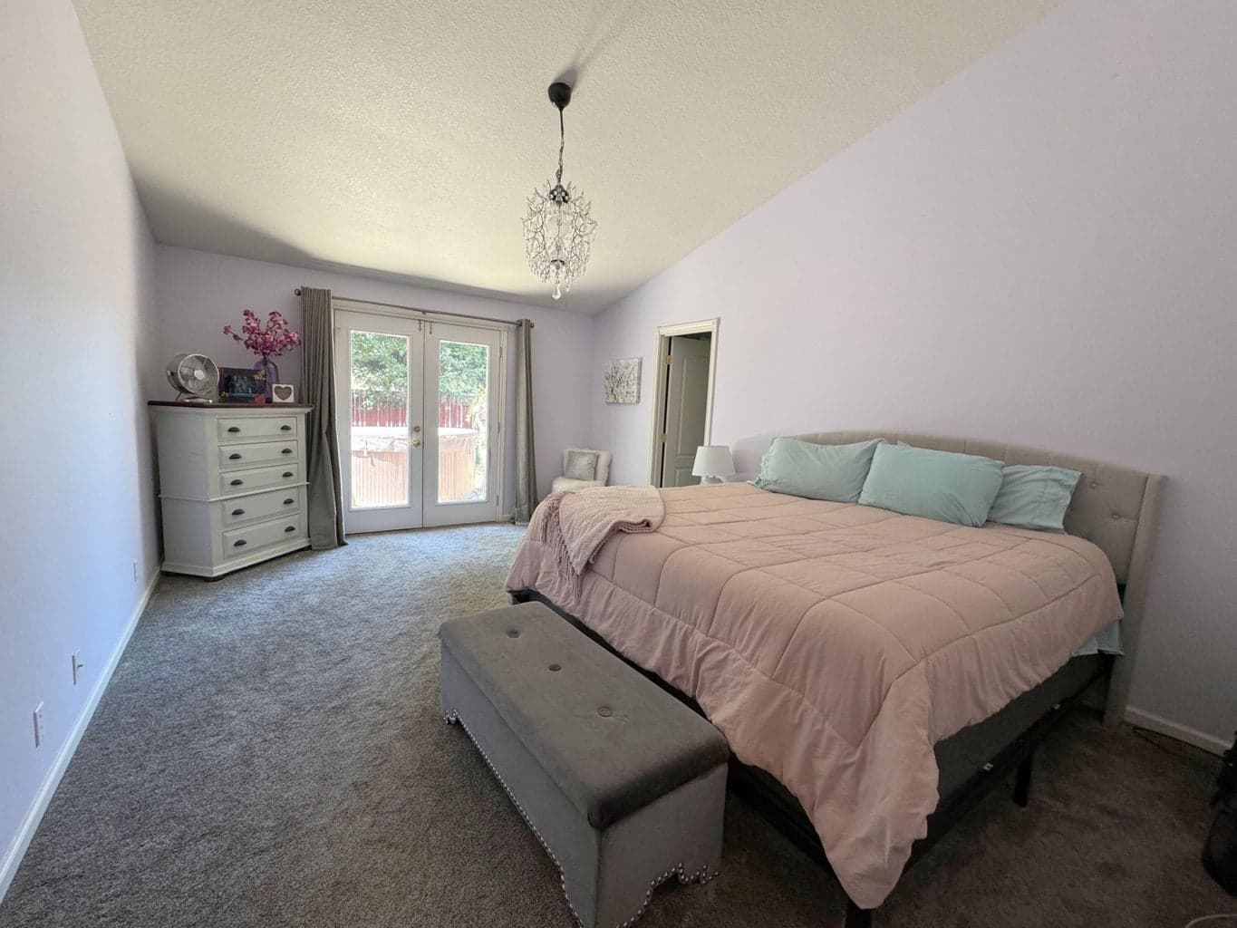 Primary Bedroom French Doors to hot tub and stamped patio.