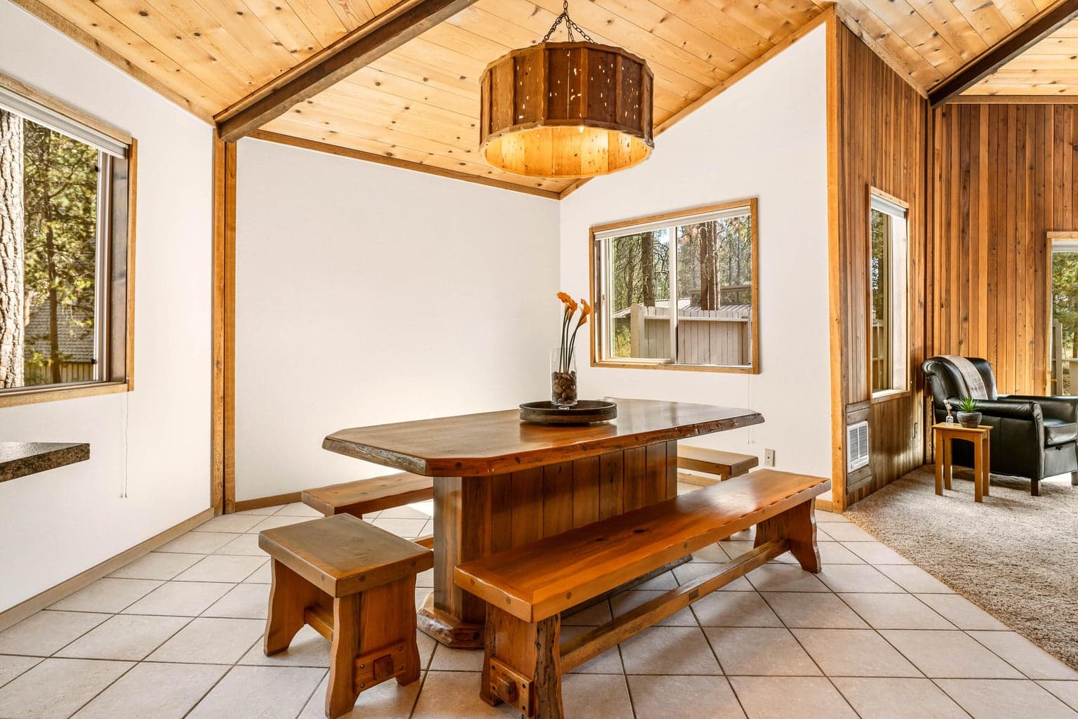 Artisan made wood dining set & chandelier continue the Sunriver vibes.