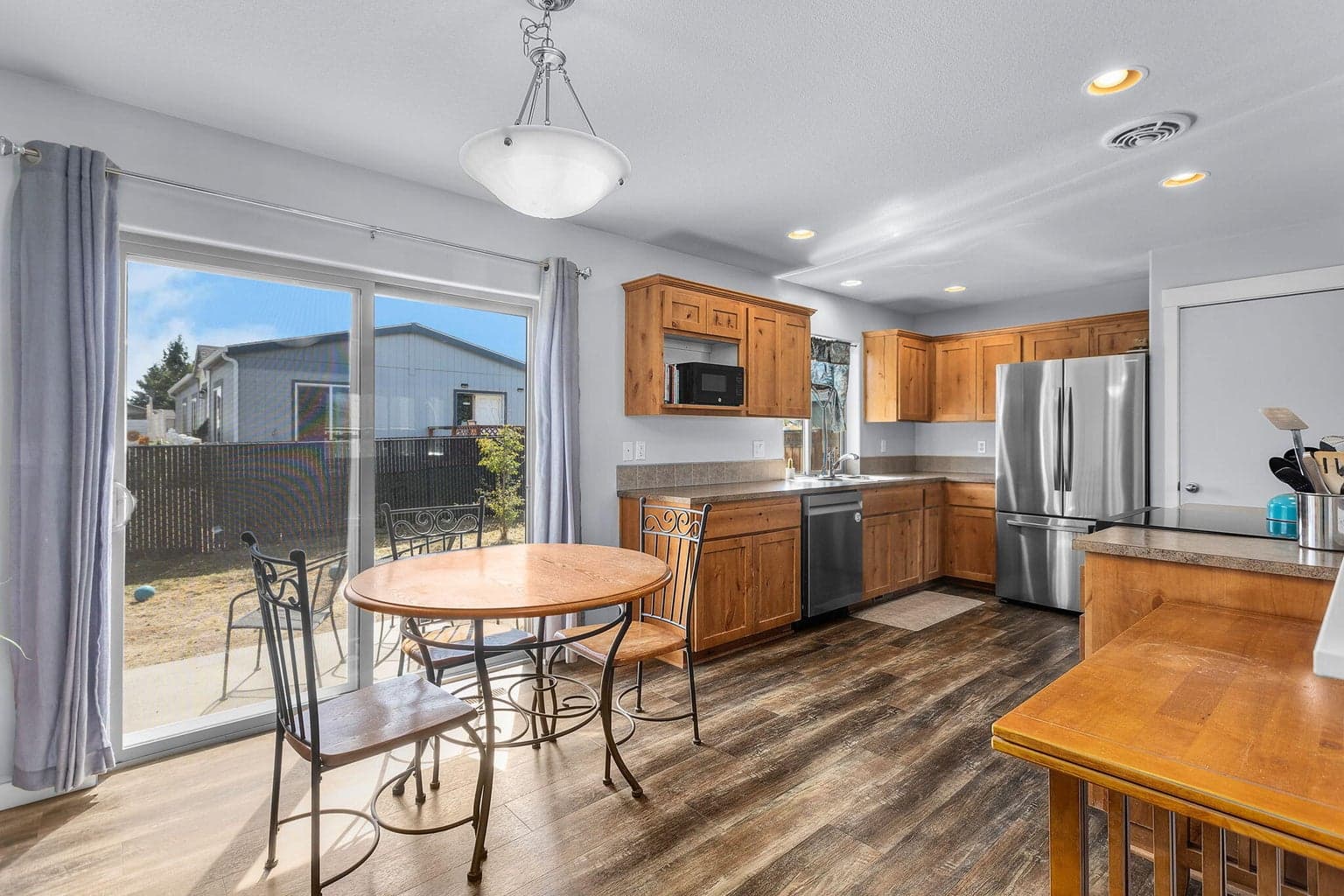Open kitchen w/plenty of storage, SS appliances, dining area w/patio access.