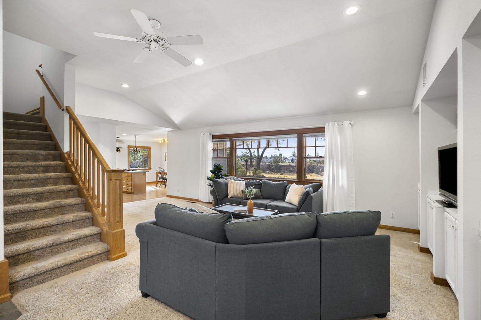 The living room has large windows to let in light and the views