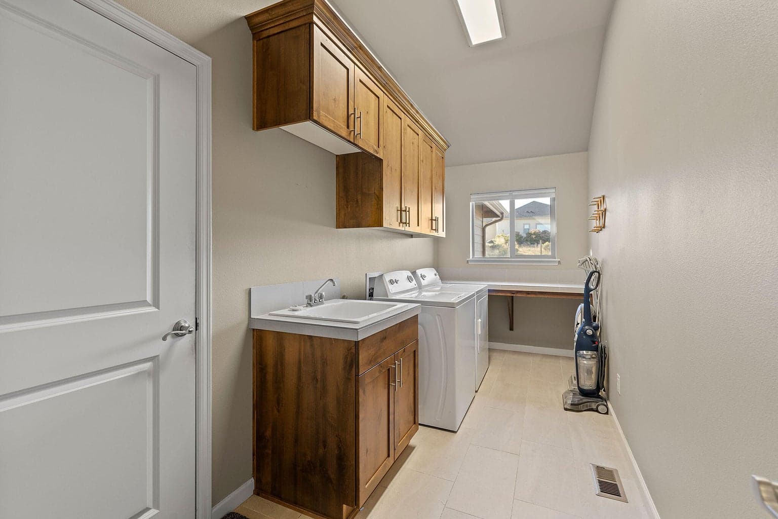 Laundry Room with folding shelf and utility sink.