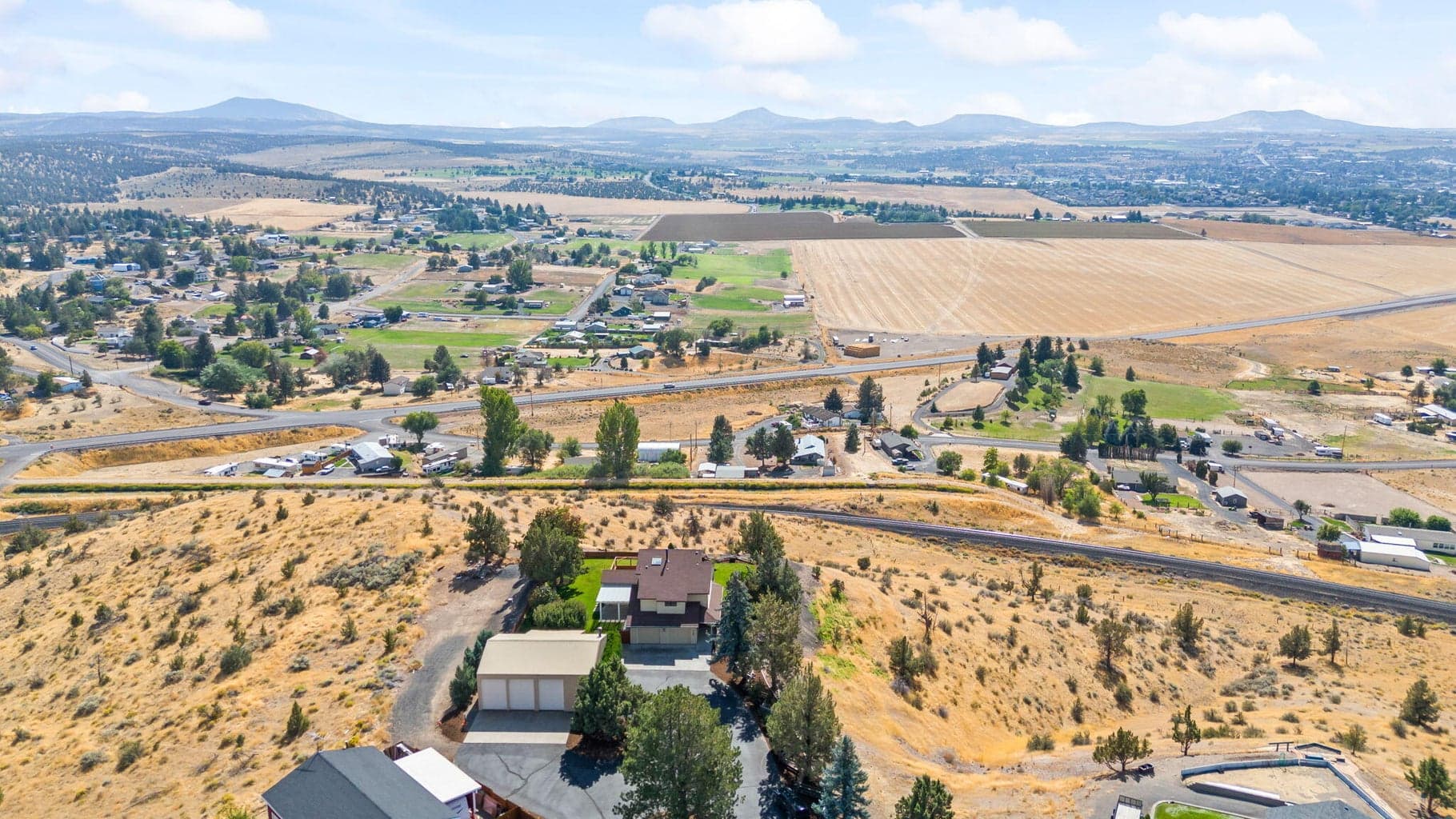 Home on Point Overlooking Farmland, City of Madras, Valley Below with Grizzley Mt, Grey Butte, Haystack Butte and Juniper Butte in the Background