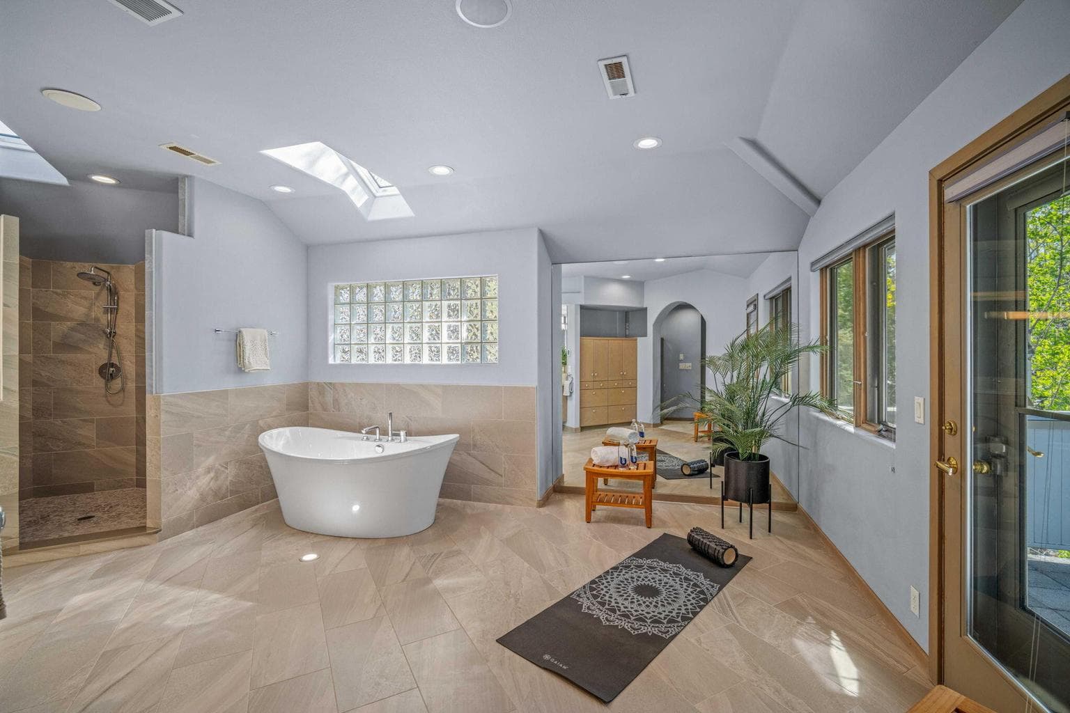 Spa-inspired primary bath with work out area and private balcony