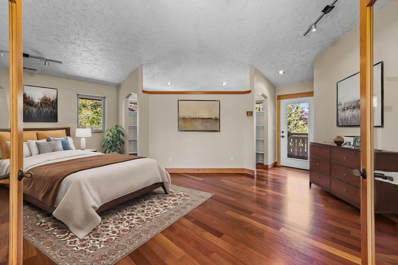 Virtually Staged - Primary Suite on upper level w/hardwood floors.