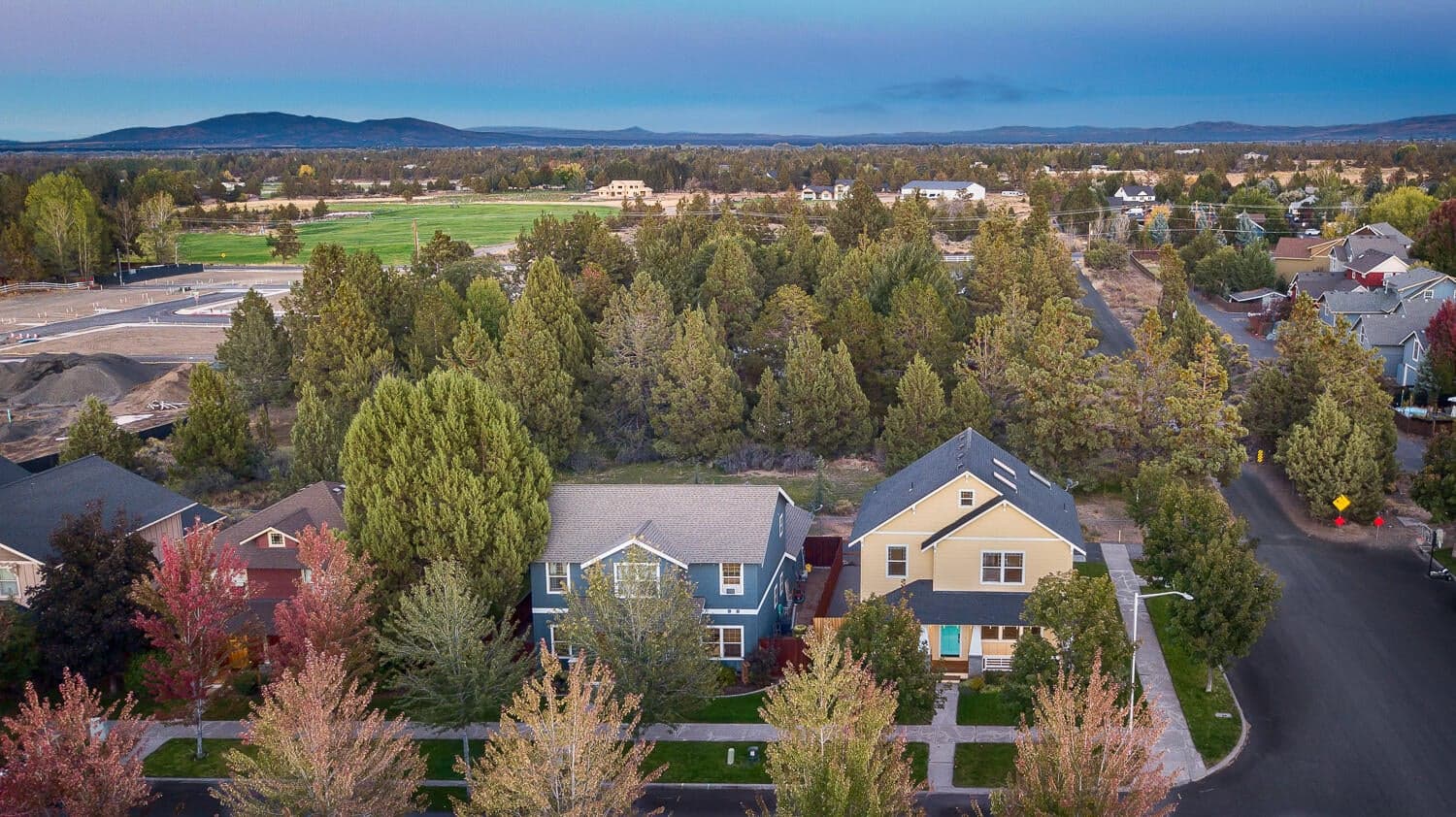 Quiet corner lot backing up to private treed property with one home