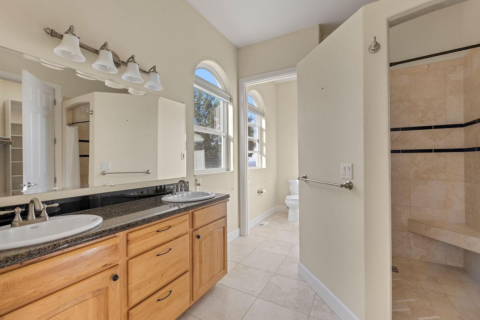 Double vanity with walk in tile shower.