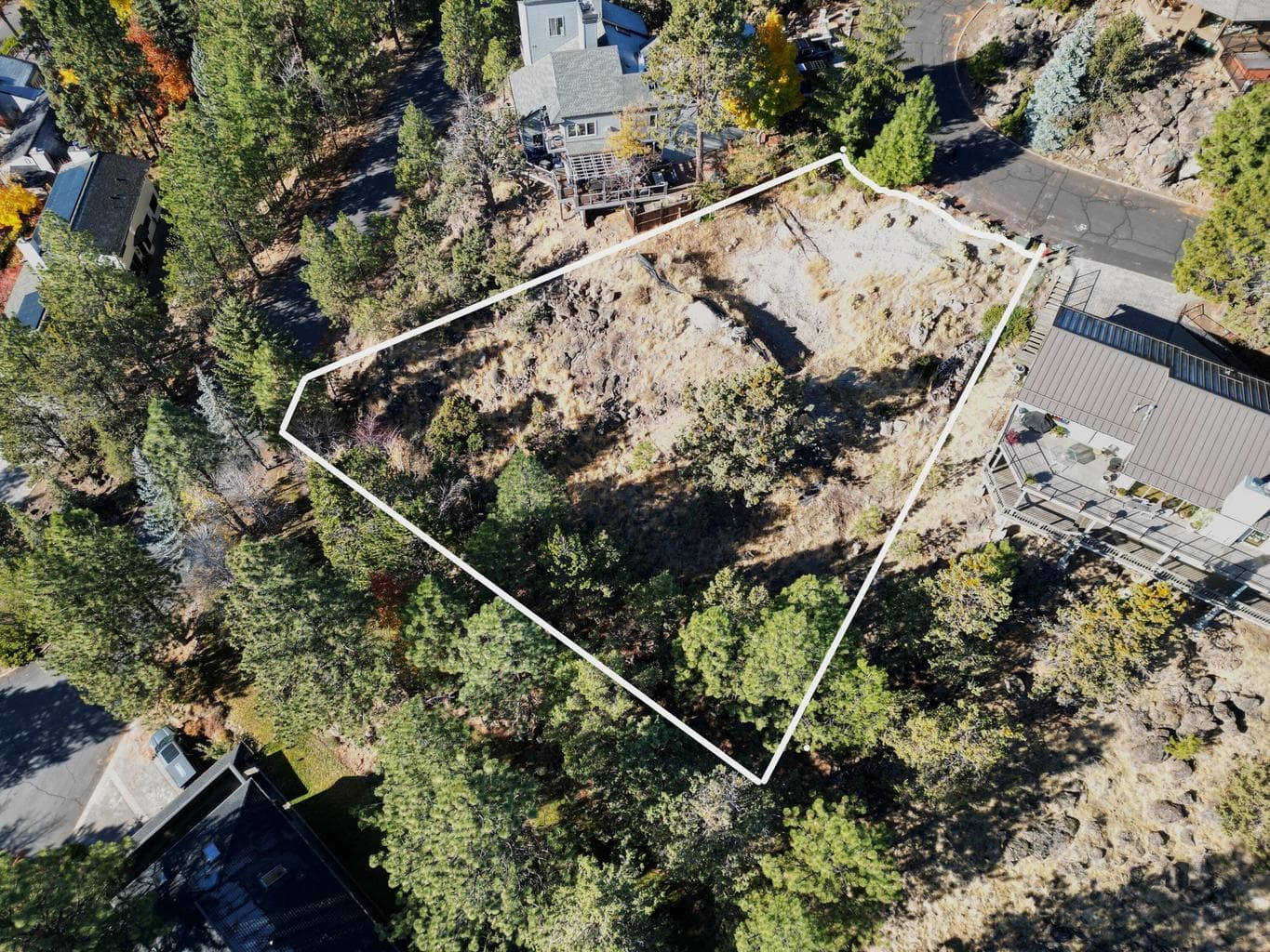 Tucked near the end of a peaceful cul-de-sac, this homesite offers a rare blend of seclusion and convenience—just minutes from the vibrant shops and restaurants of Newport Avenue and Northwest Crossing. Enjoy nearly 180-degree southeast views that capture brilliant sunrises, glowing winter sunsets, and twinkling city lights by night. The property is thoughtfully positioned to shelter you from prevailing winds and intense afternoon sun, offering a comfortable, year-round outdoor experience. Surrounded by natural beauty, it’s the perfect canvas to create a home that embraces both tranquility and connection to Bend’s best amenities.