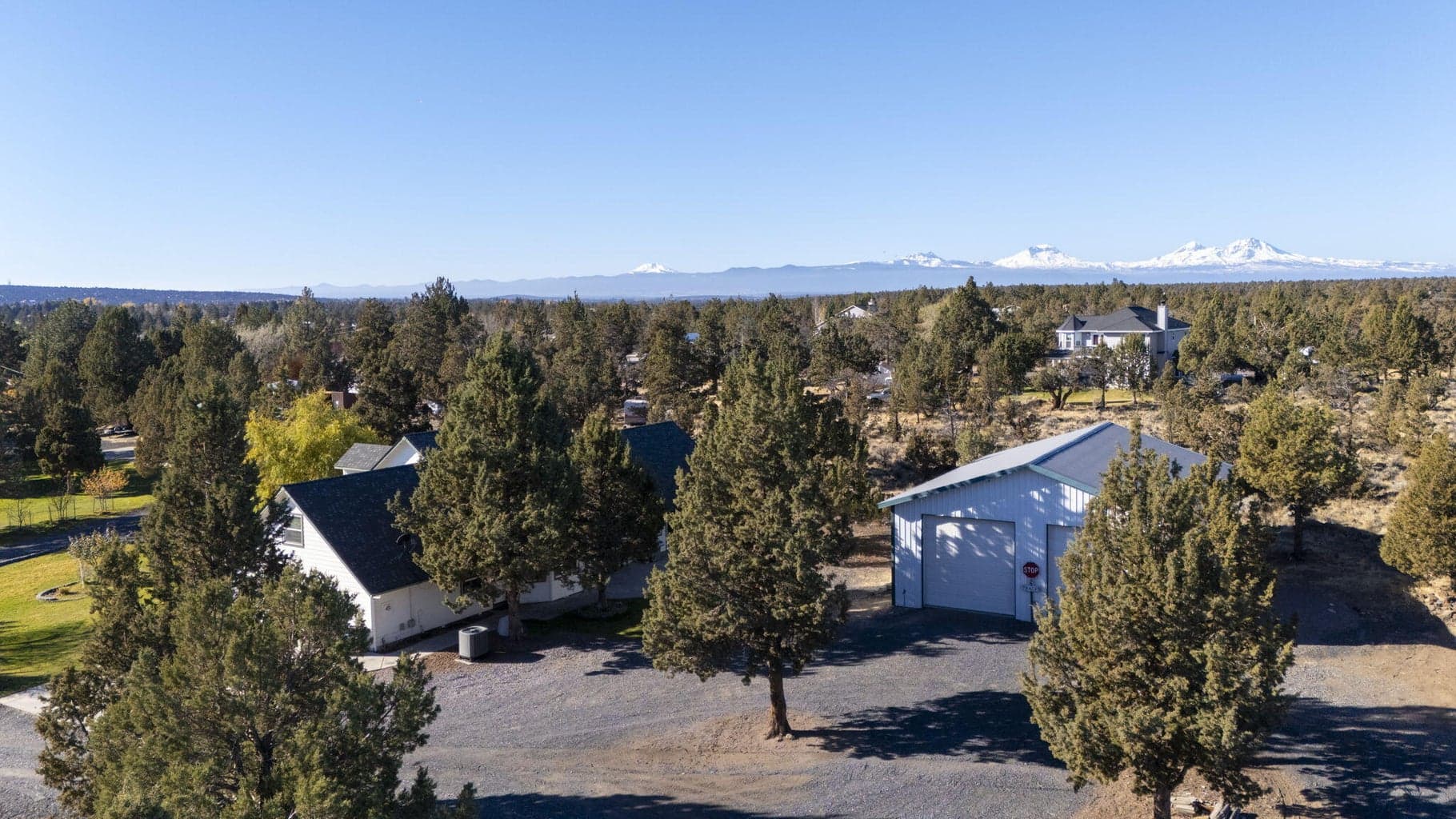 White shop on right, main house on left