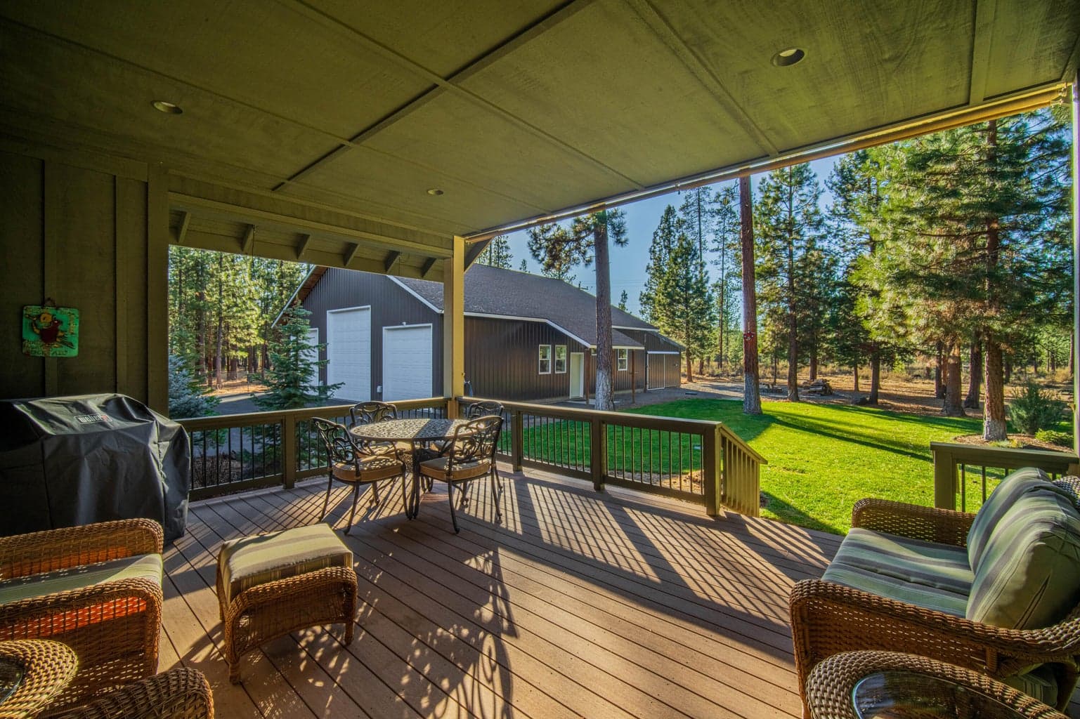 The large, covered back deck provides outdoor living space plus room for the BBQ and a dining area,