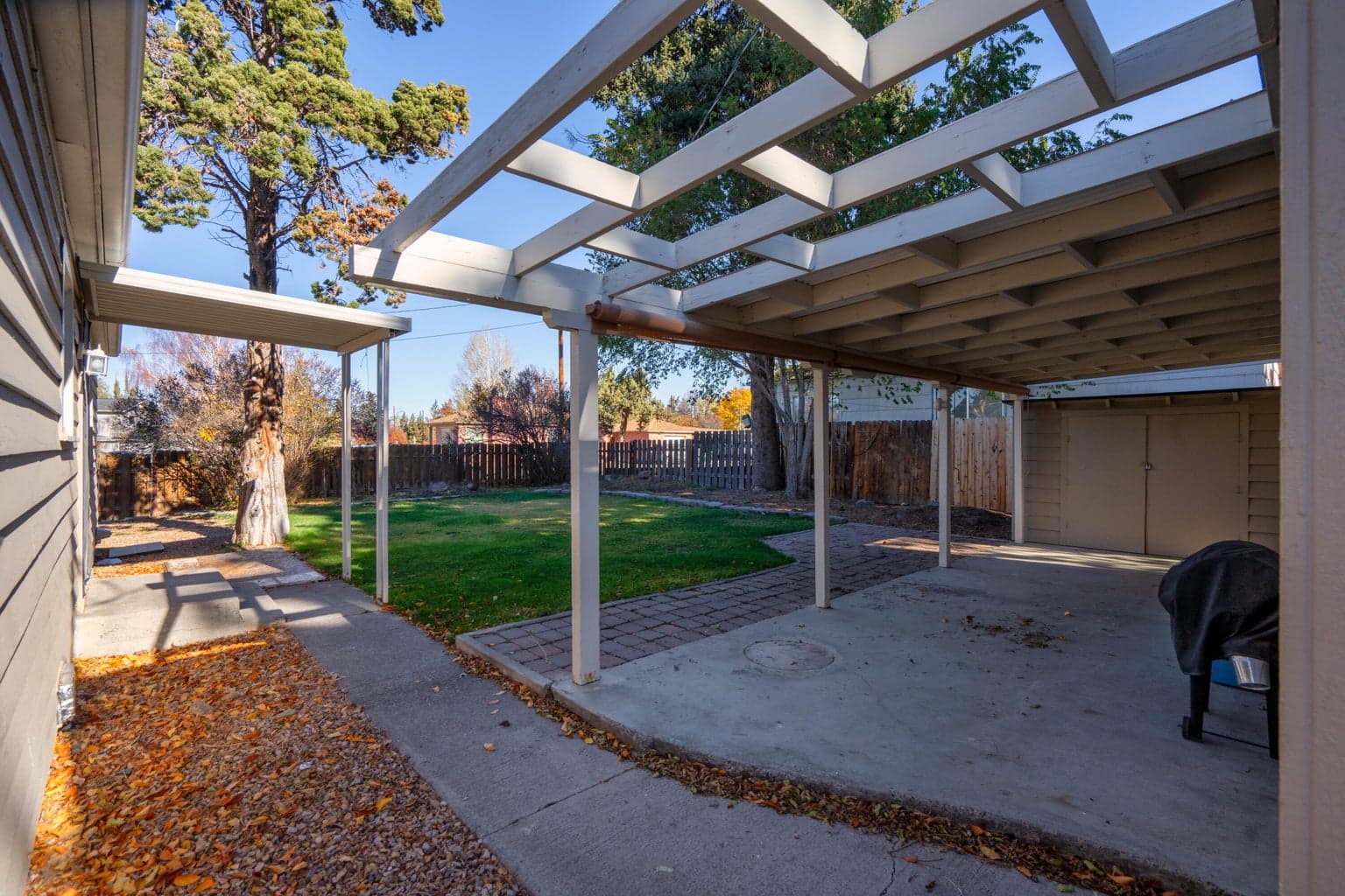 ADU has access to the concrete pad up to the posts on the porch and 1 shed, Yard is the main house.