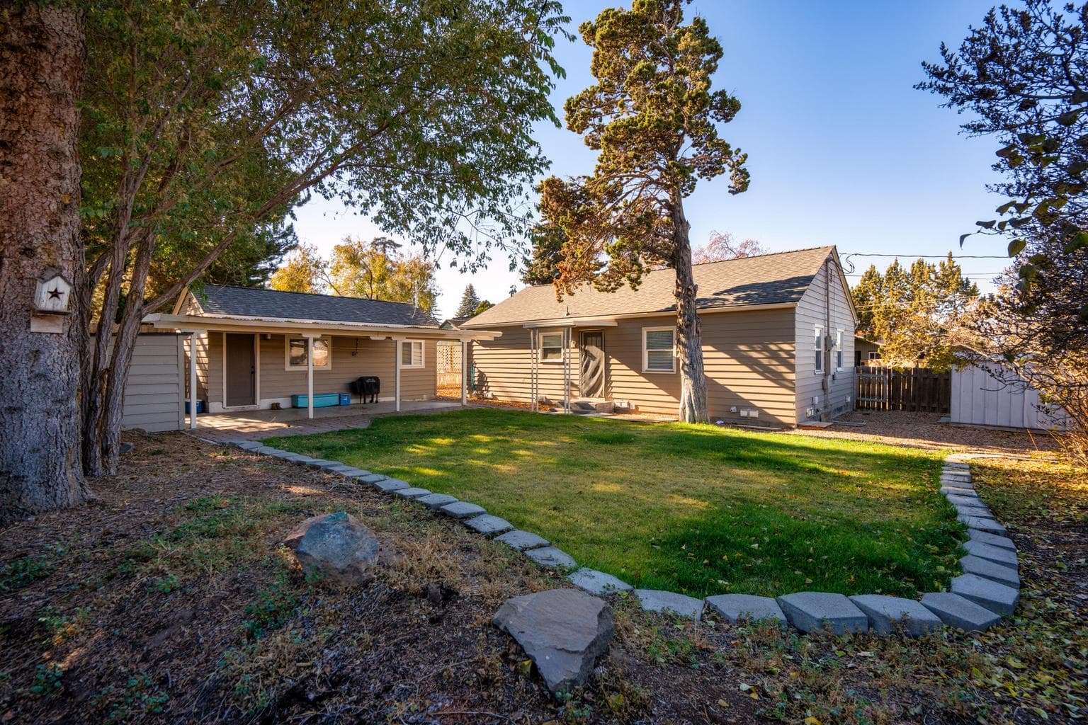 ADU has access to the concrete pad up to the posts on the porch and 1 shed, Yard is the main house.