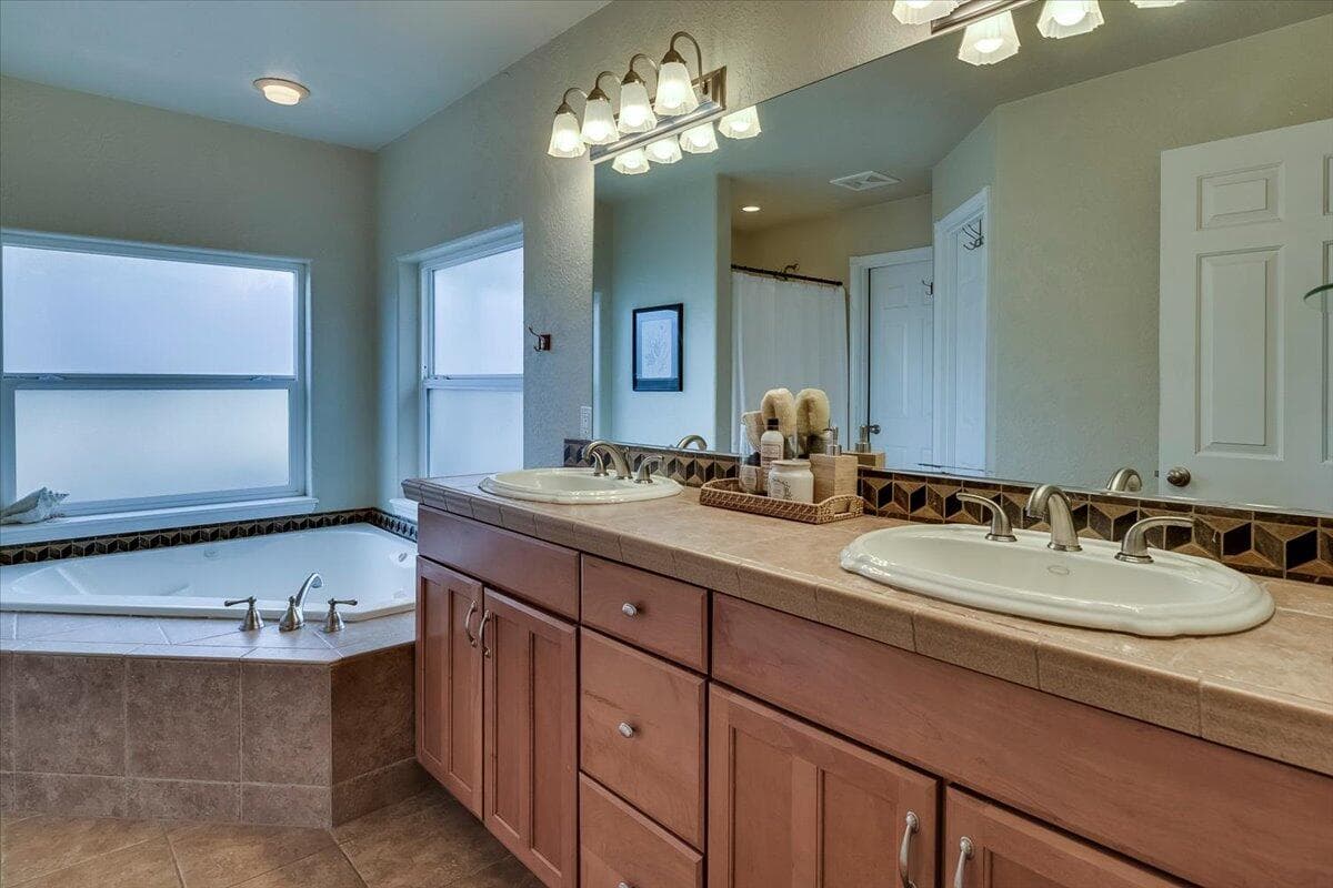 Double vanity, soaker tub, shower, walk-in closet and separate toilet room