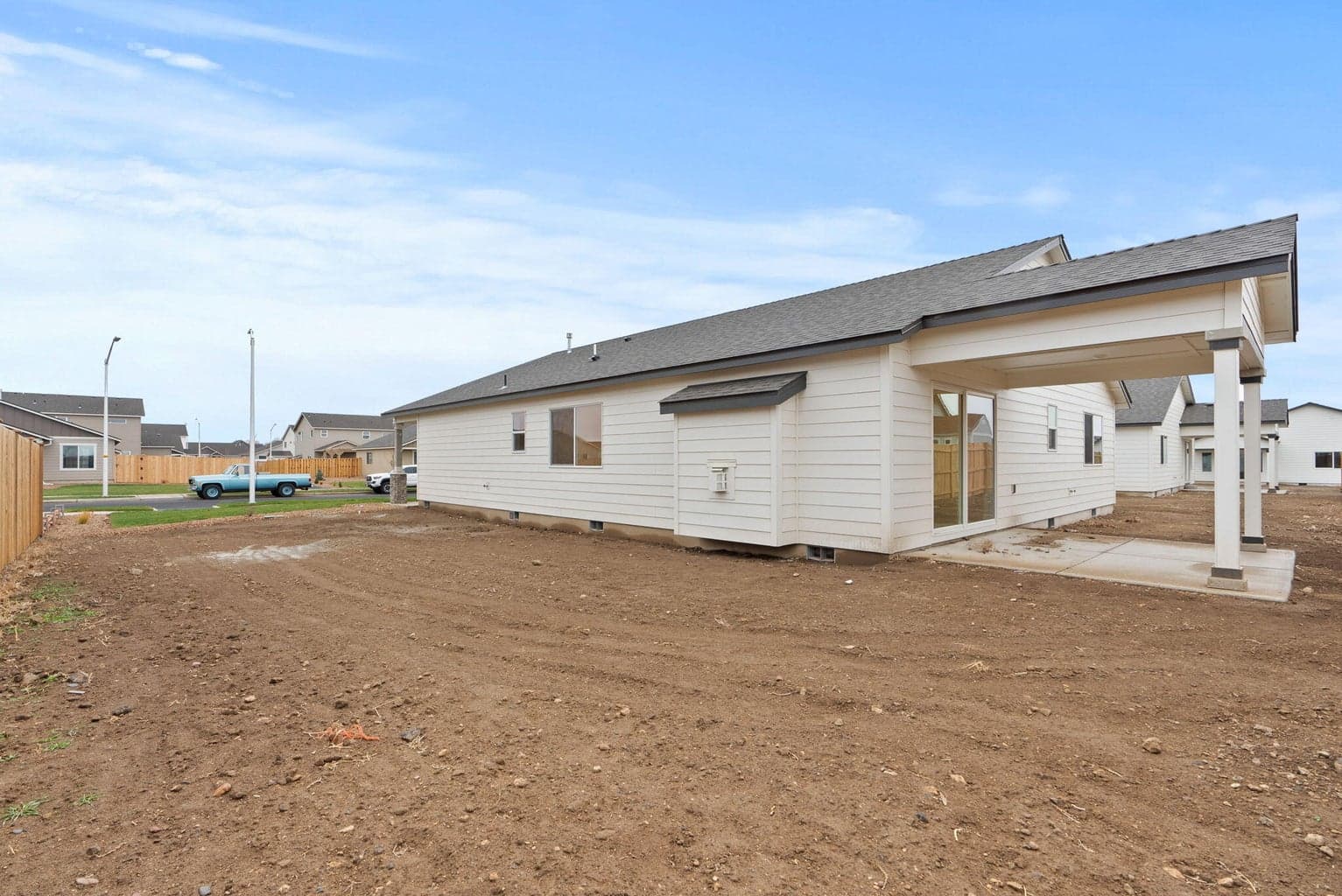 large side yard with covered patio