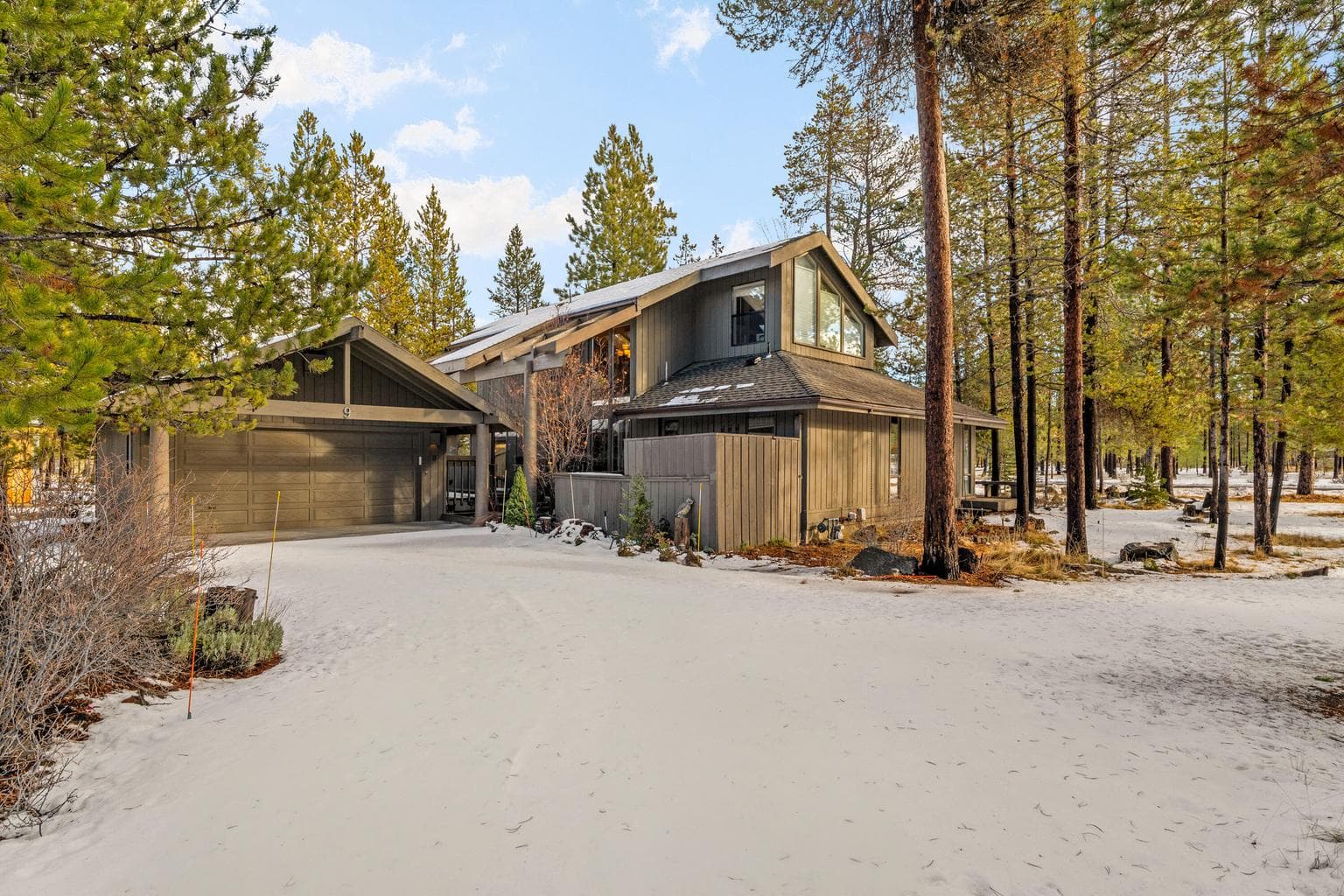 Outdoor features include a large covered deck, hot tub, detached two-car garage and storage shed.