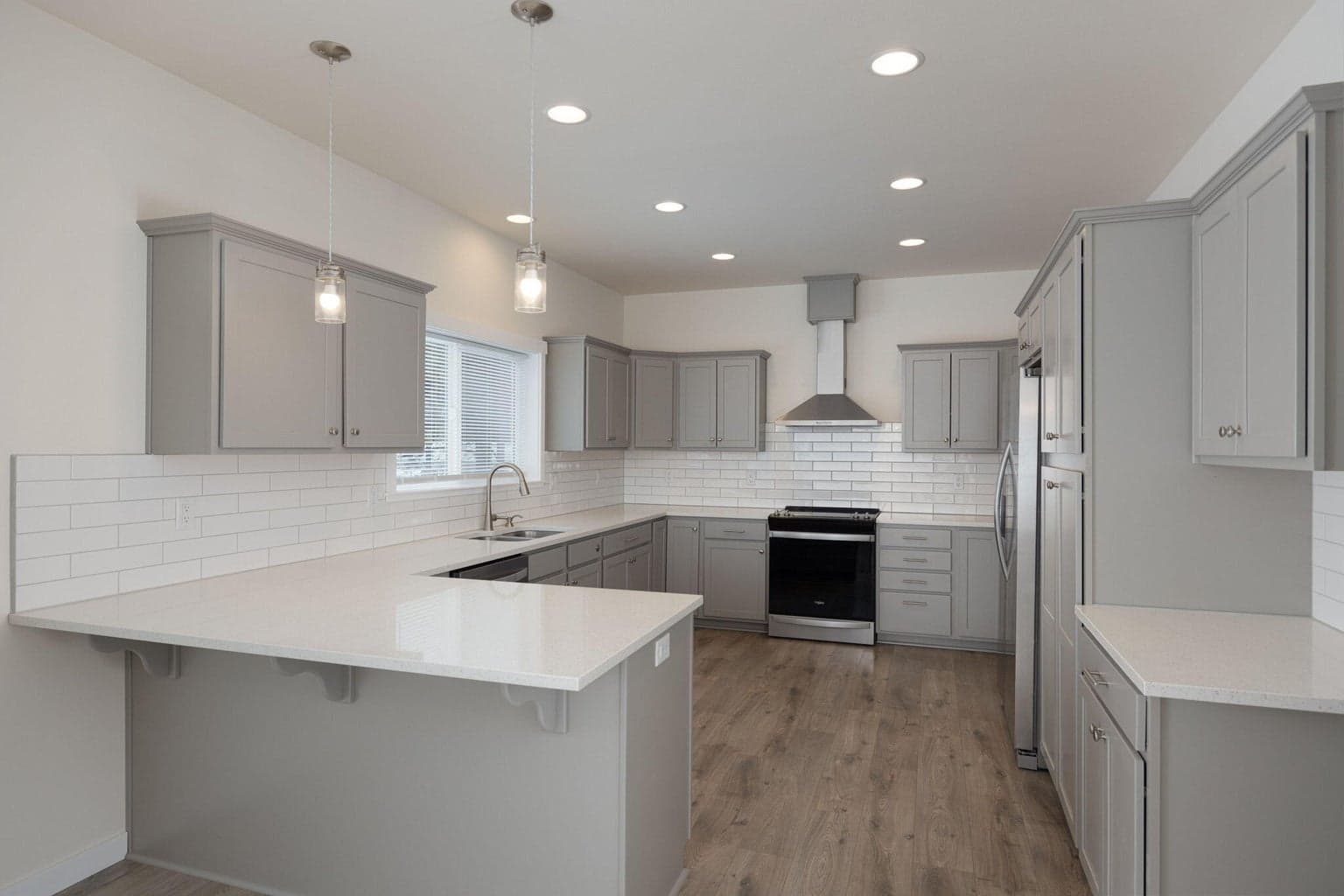 Kitchen has quartz counters and pullouts in the cabinets