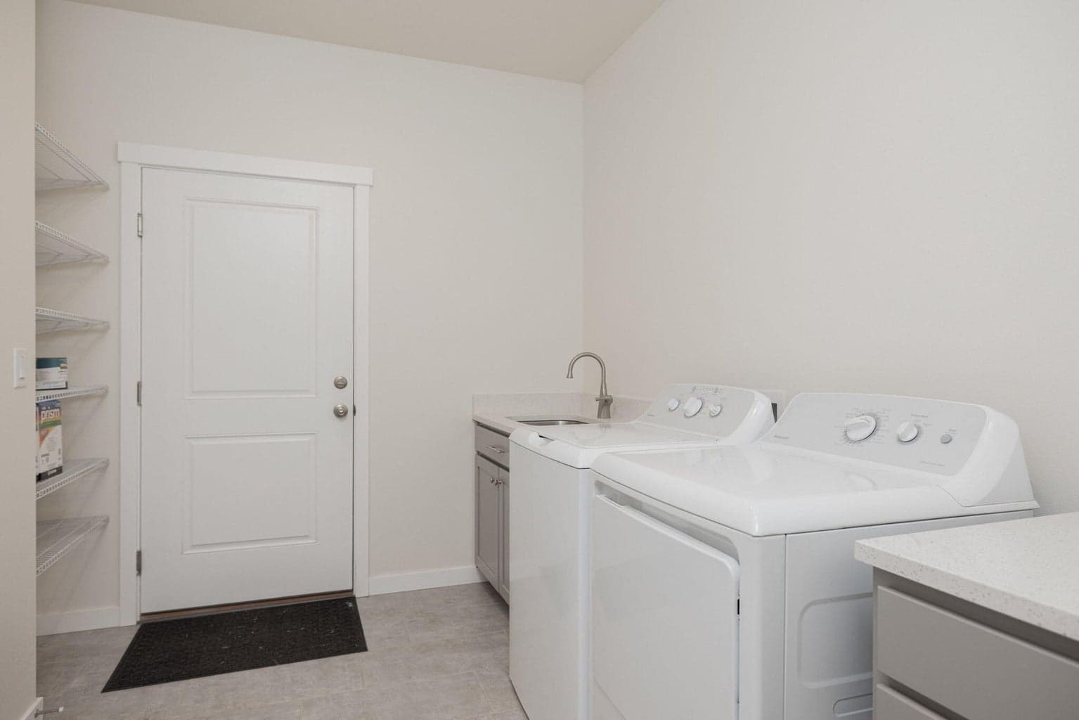 nice sized laundry with sink and folding area.