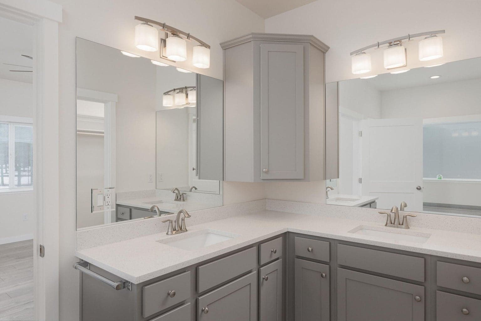 double vanity with corner cabinet in primary suite
