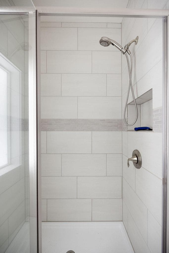 tile walk-in shower in primary suite