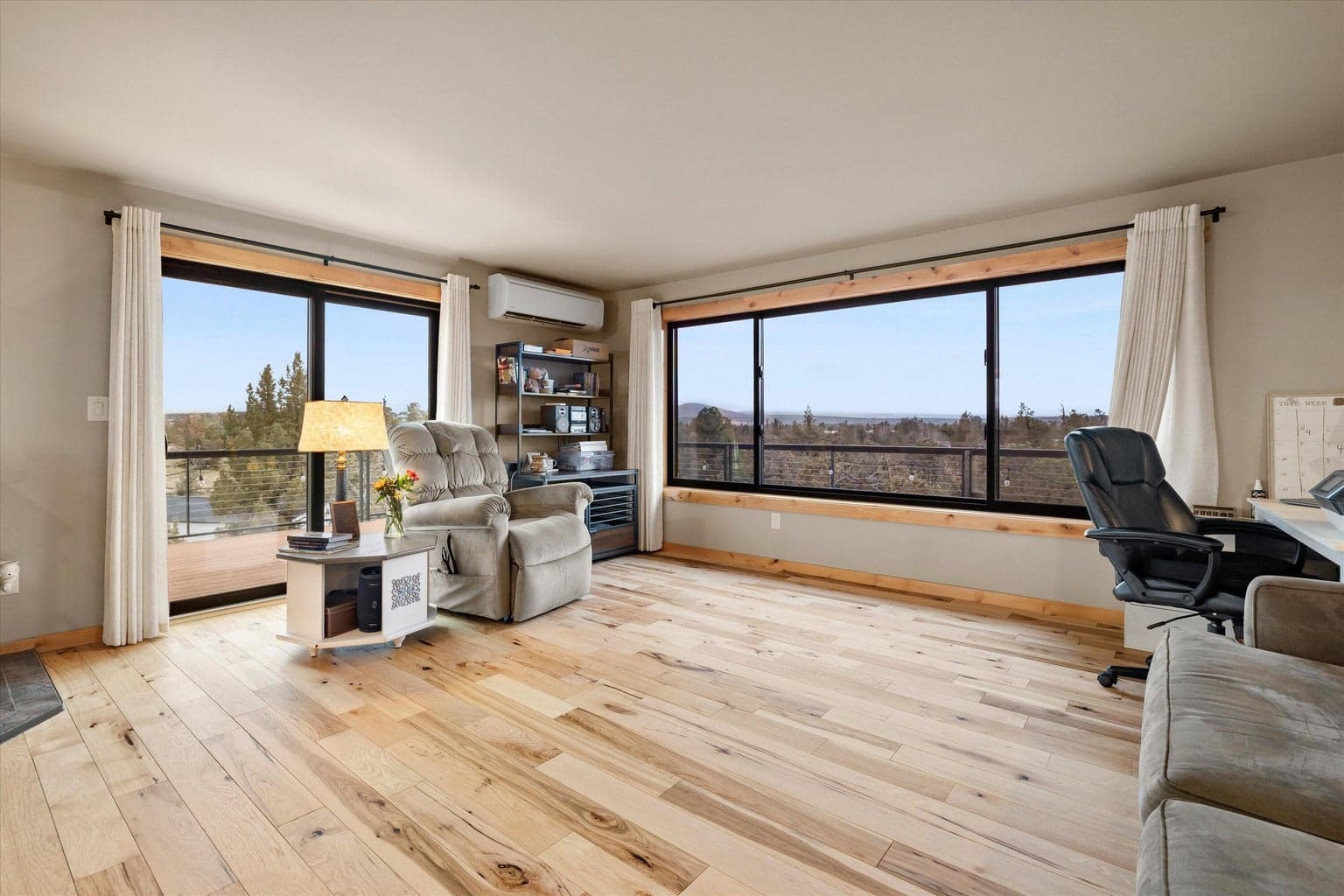 Serene setting with relaxing views outside. Enjoy the solid wood flooring, too.