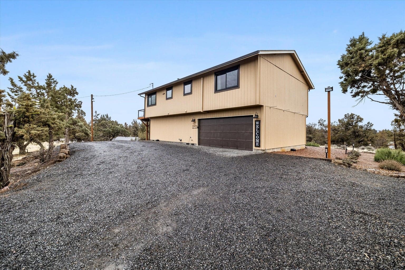 View of garage side of home, and generous parking.