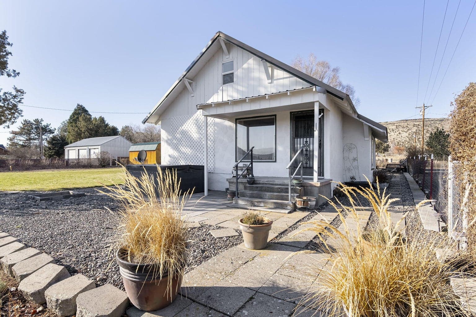 The house from the street showing yard and driveway.