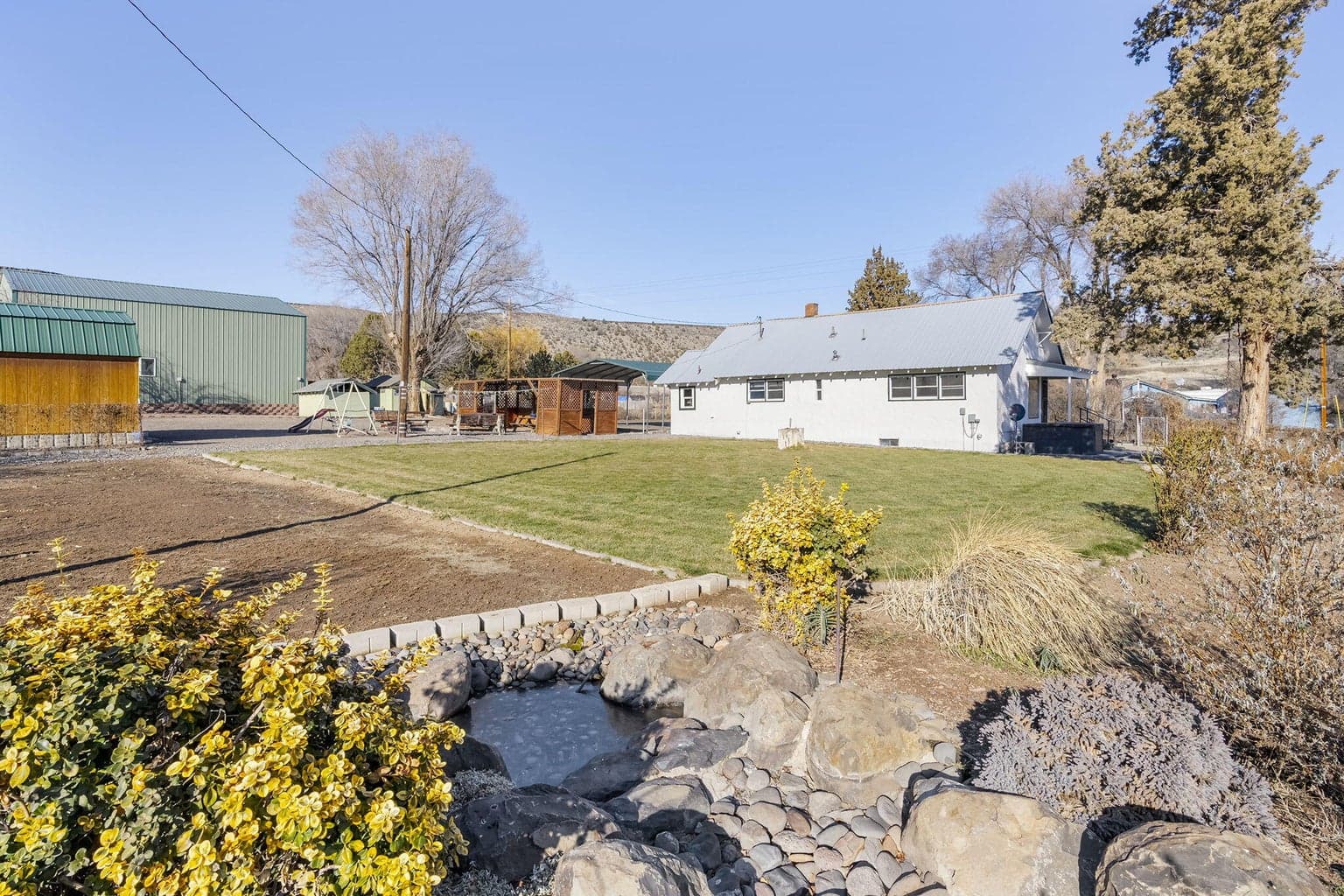 A spacious and well-maintained lawn area offers a clean, open landscape across the lot.
