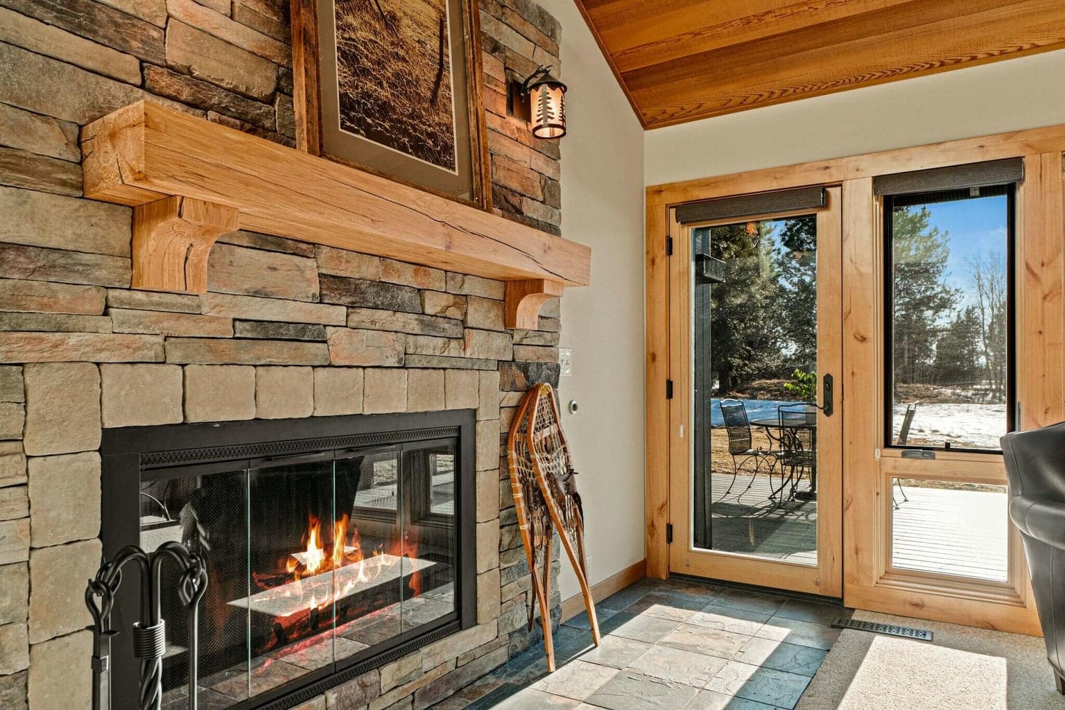 Stacked stone wood burn fireplace and custom mantle.