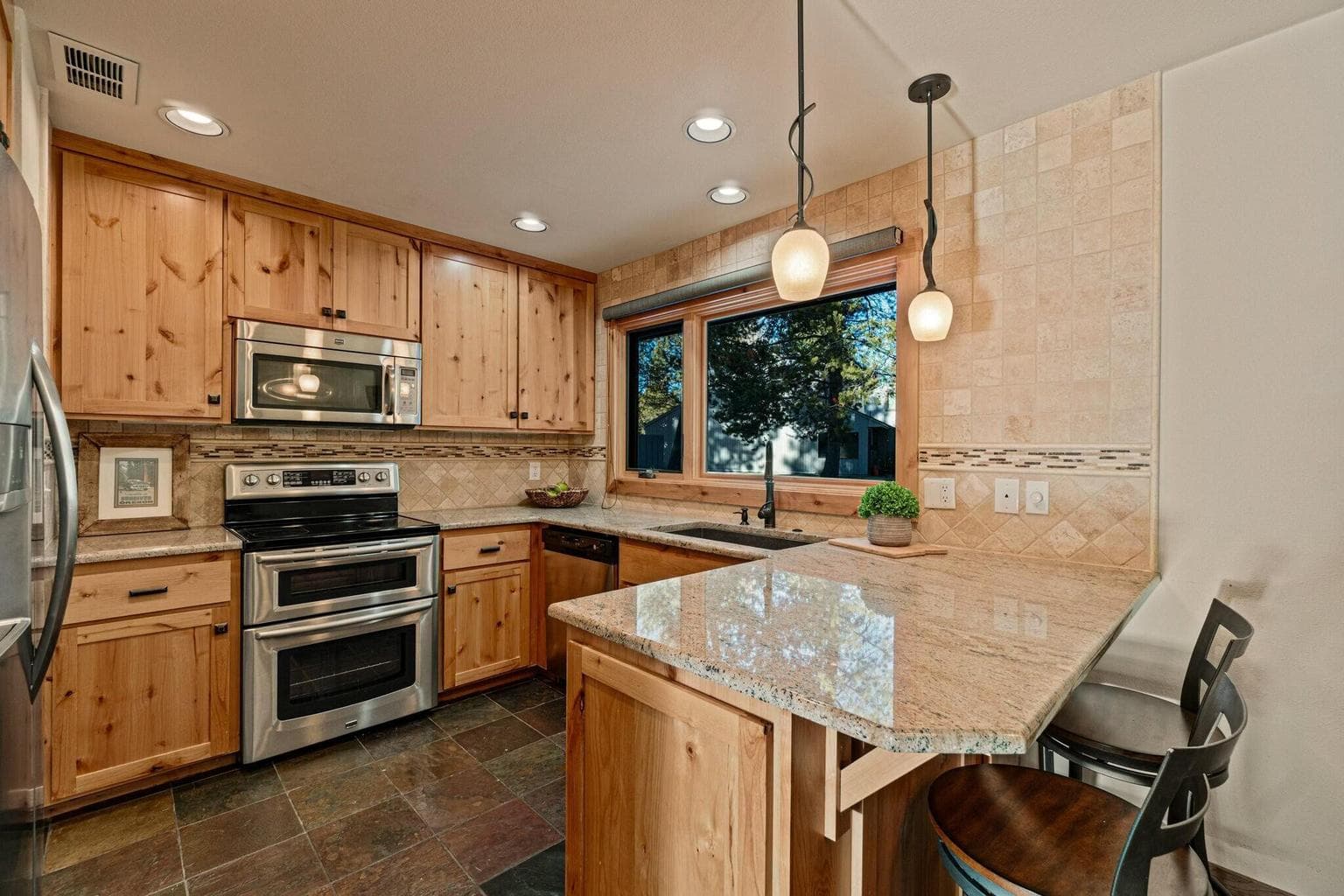 Remodeled in 2016 with custom pull-out drawer systems, ample cabinetry, double oven and Kitchen Aid dishwasher.