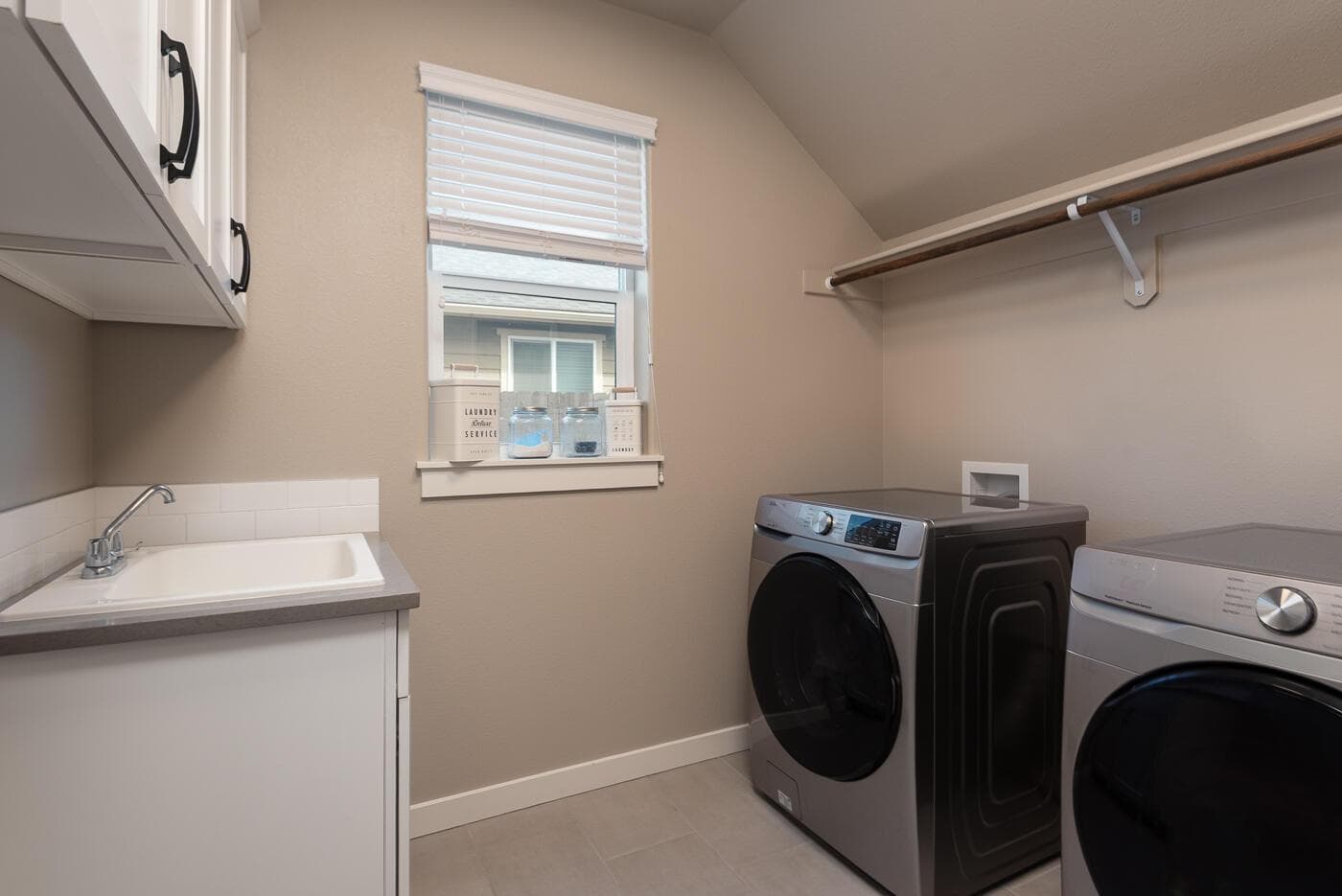 Downstairs laundry room with utility sink