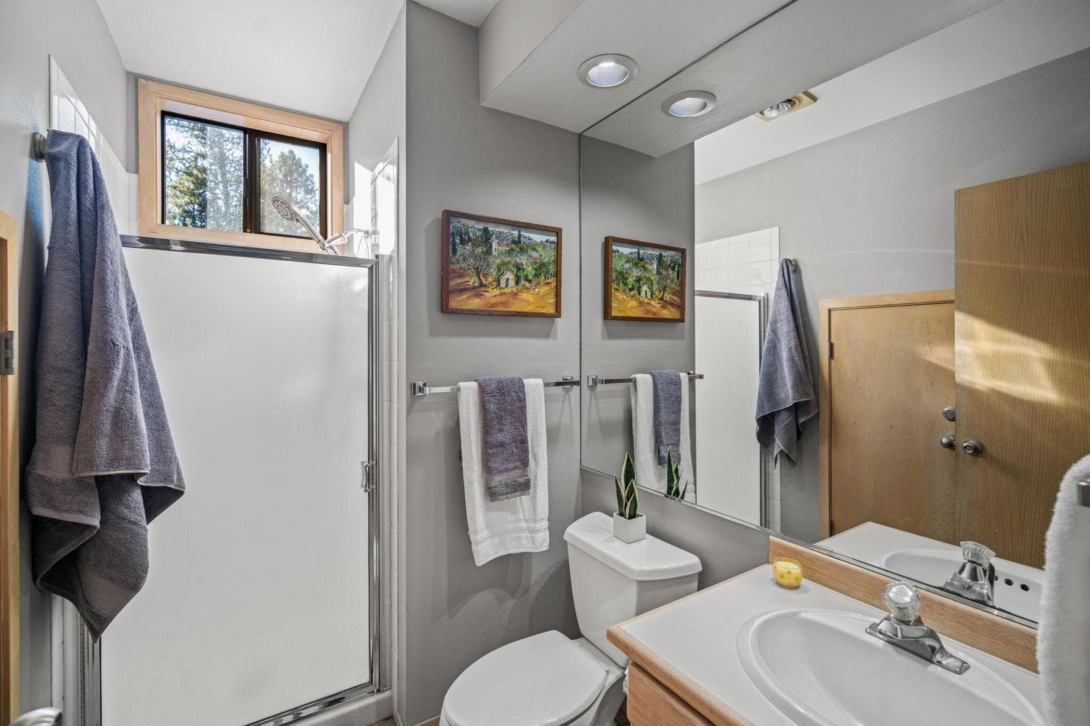 This full bath is next to the bunk room but also as the primary bath downstairs. Walk in shower.