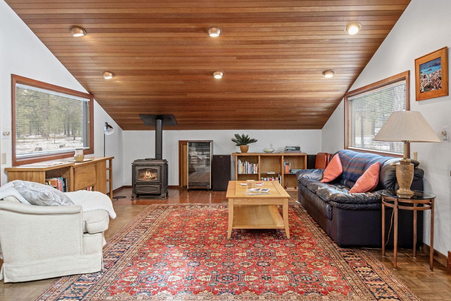 Family room with gas heat stove and parquet flooring.