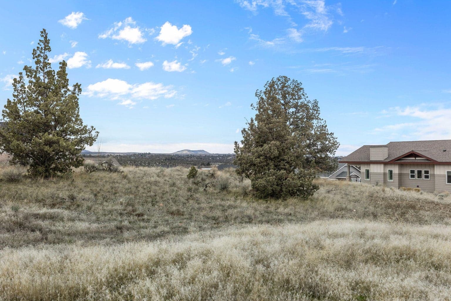 Landscape with horizon and sky visible beyond the property.