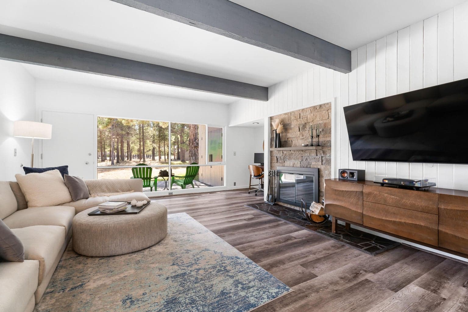 The bright and inviting family room includes a wood-burning fireplace with a beautiful, recently updated rock surround.