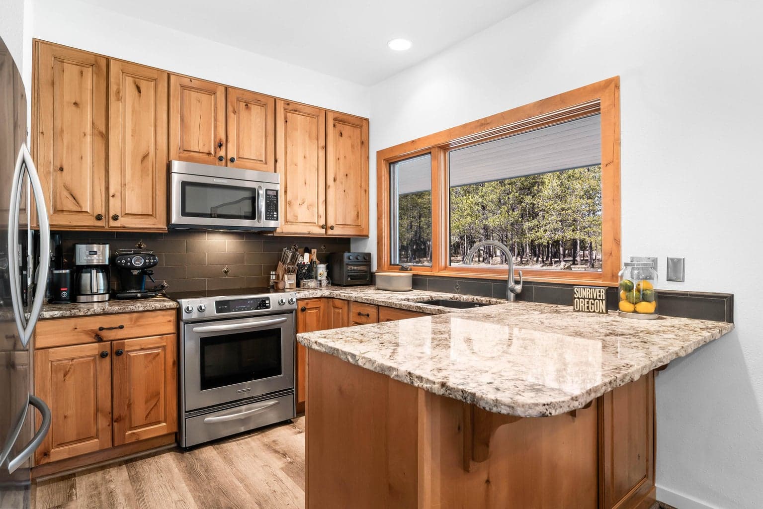 Updated kitchen with granite countertops, stainless steel appliances, and newer cabinetry.
