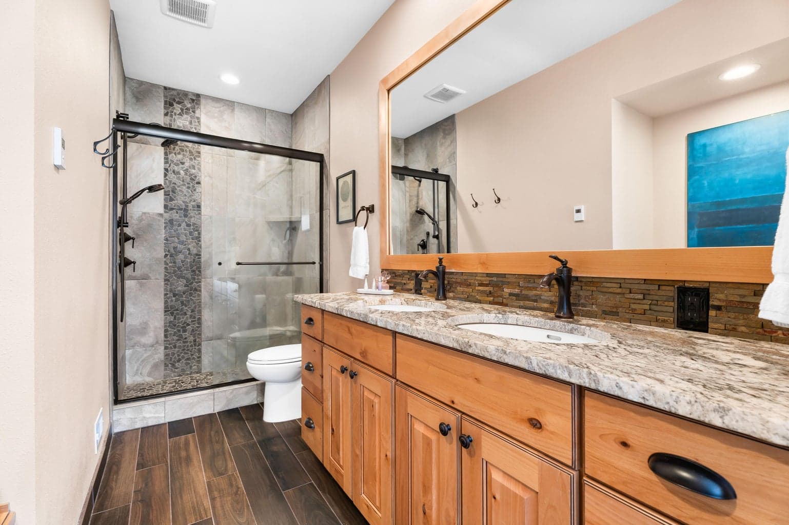 Both bathrooms are beautifully updated with granite counters, tiled showers, heated tile flooring, and newer cabinetry.