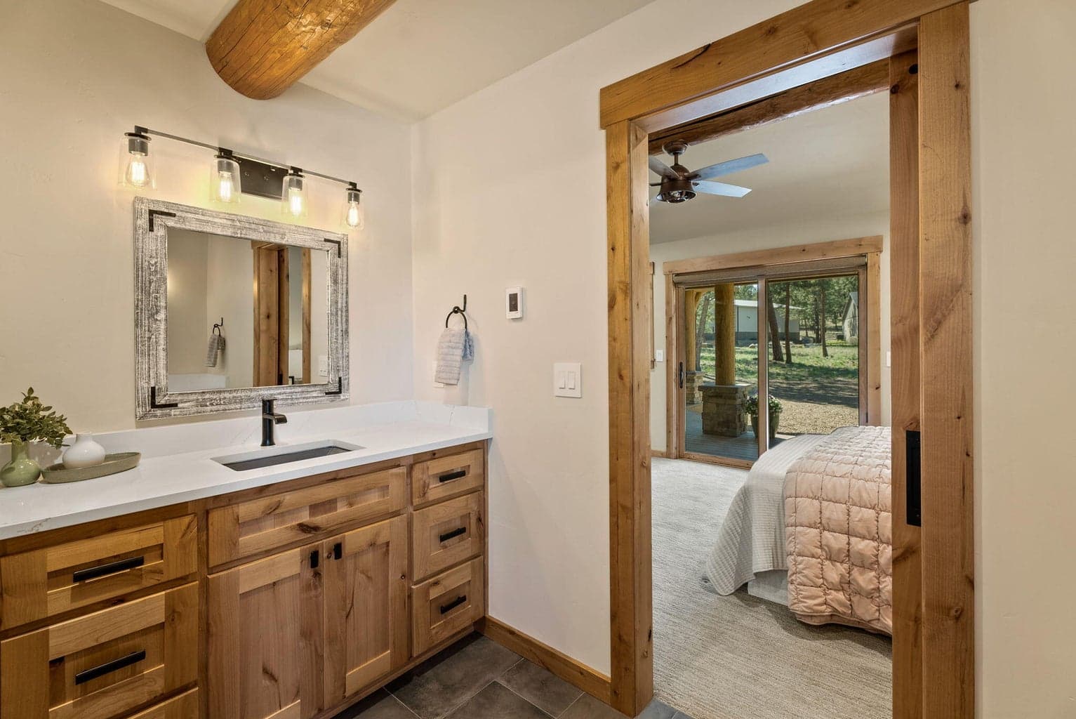 Primary ensuite bath features radiant heat tiled flooring, two solid surface vanities, soaking tub, plus glass door walk-in tiled shower.