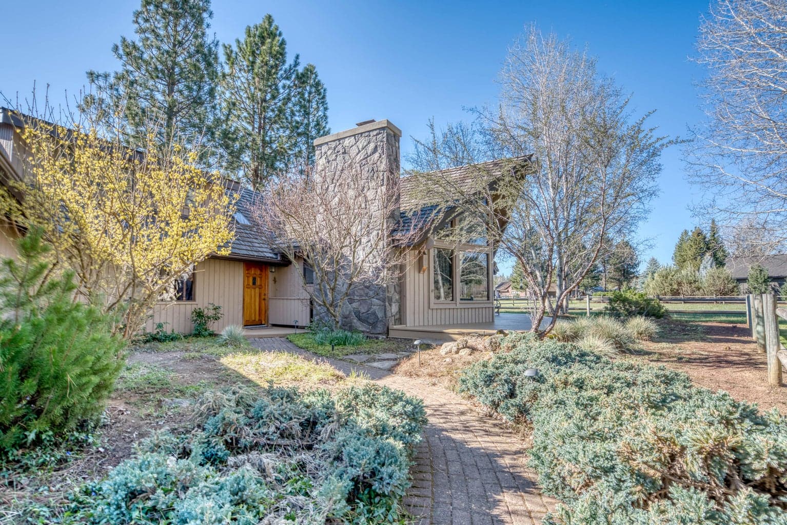 A paver pathway and landscaping enhance the main entry.