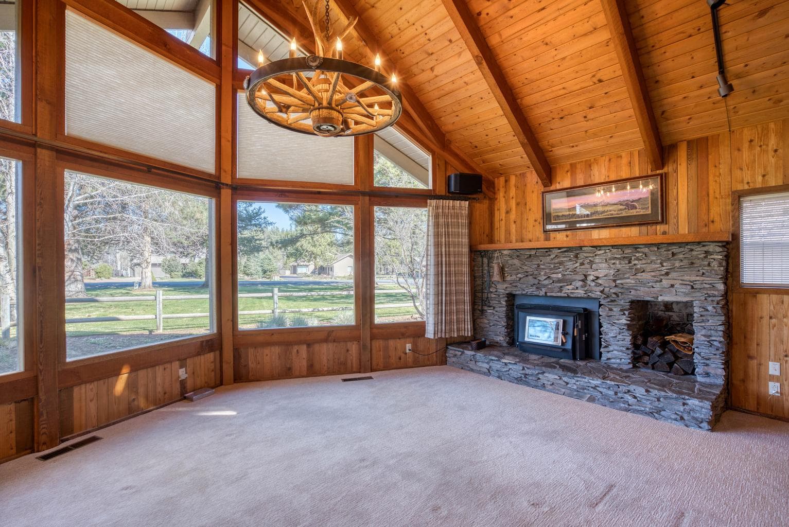 The stone hearth w/ fireplace insert and wood storage.
