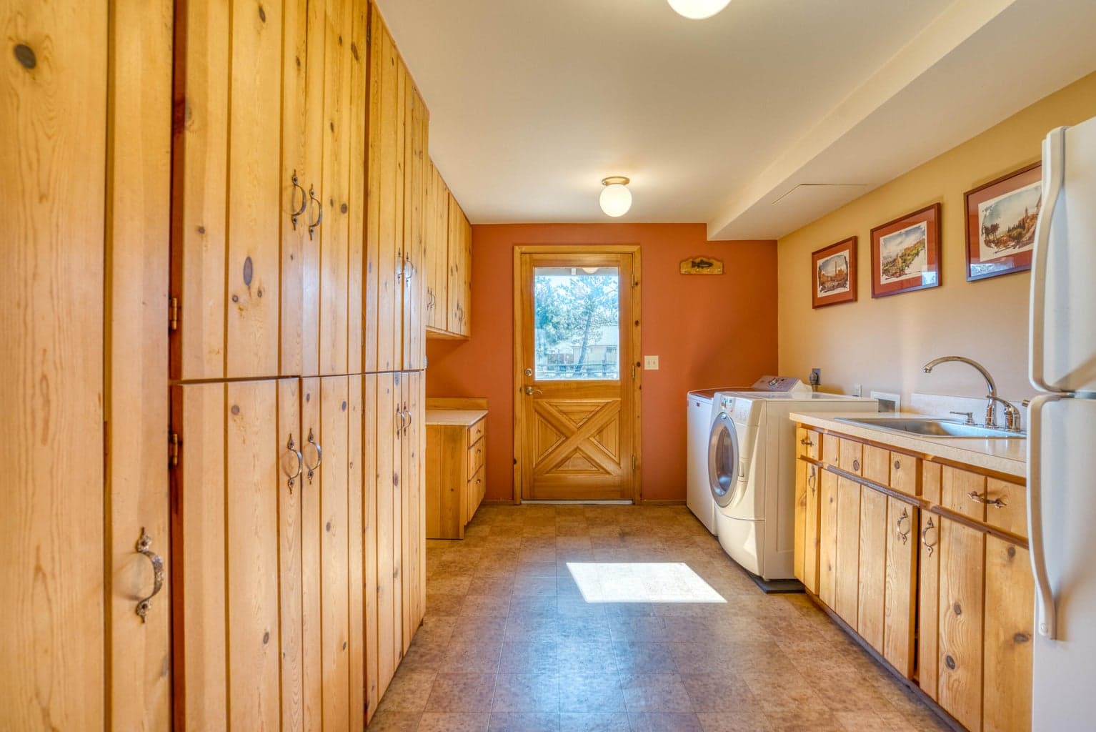 Includes washer/dryer, extra fridge and laundry sink.