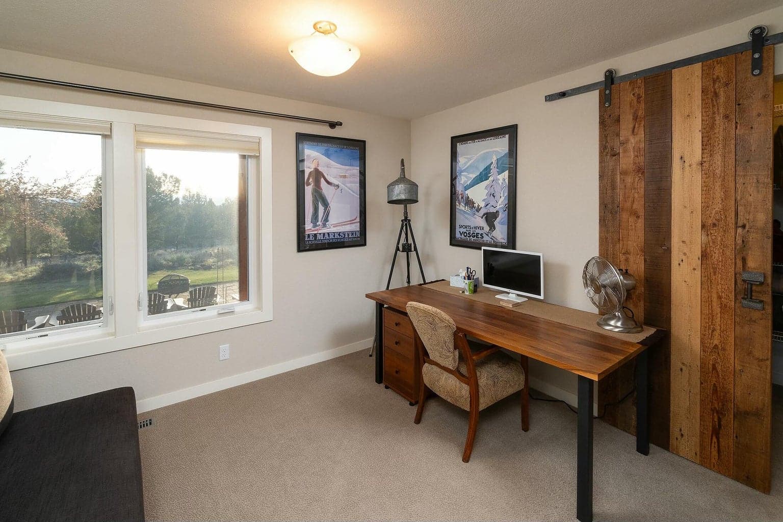 Barn door adds charm and privacy to a versatile secondary bedroom.