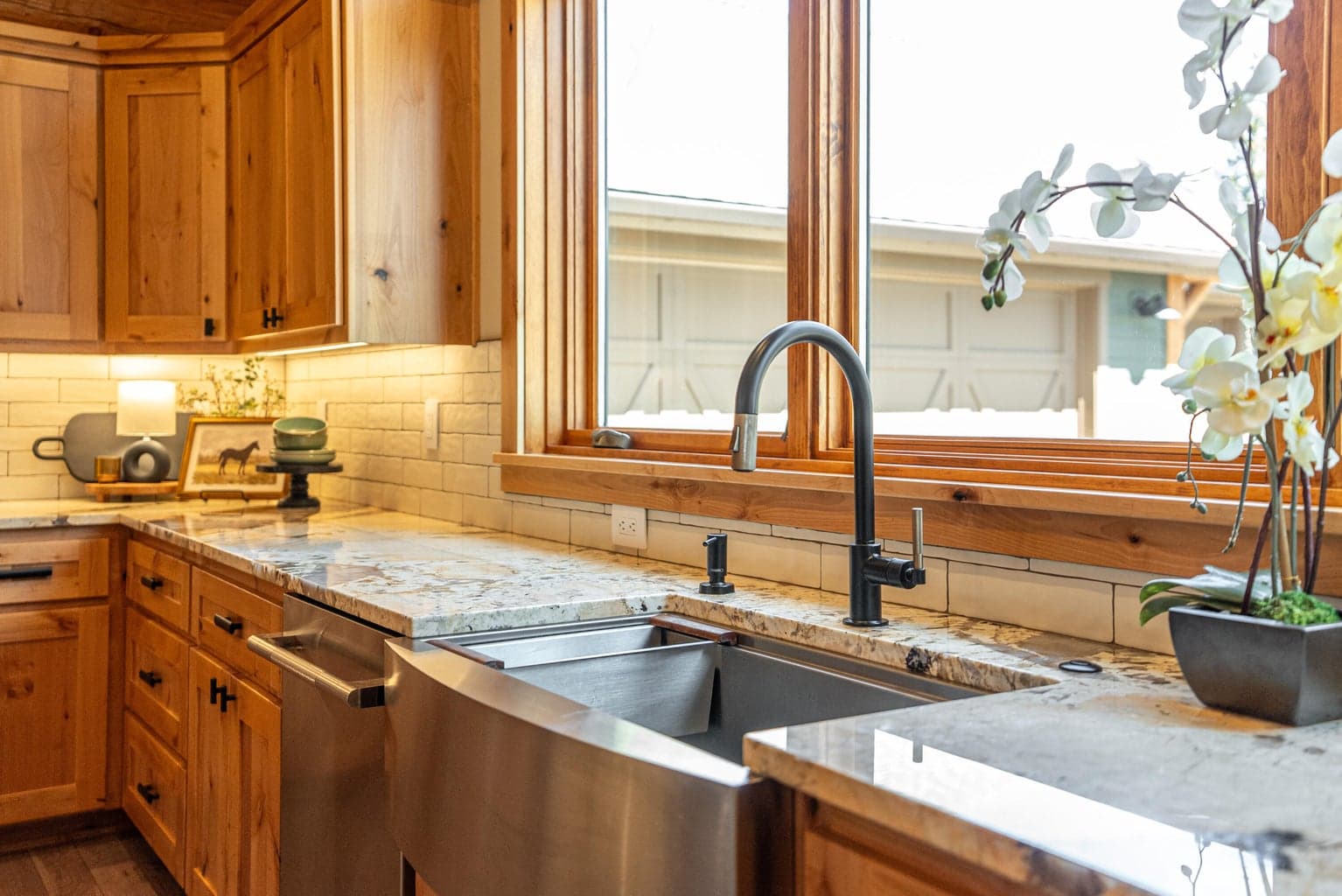 Stainless single basin sink's accessories include an inset cutting board, a roll-up drain rack, and a produce washing basin.