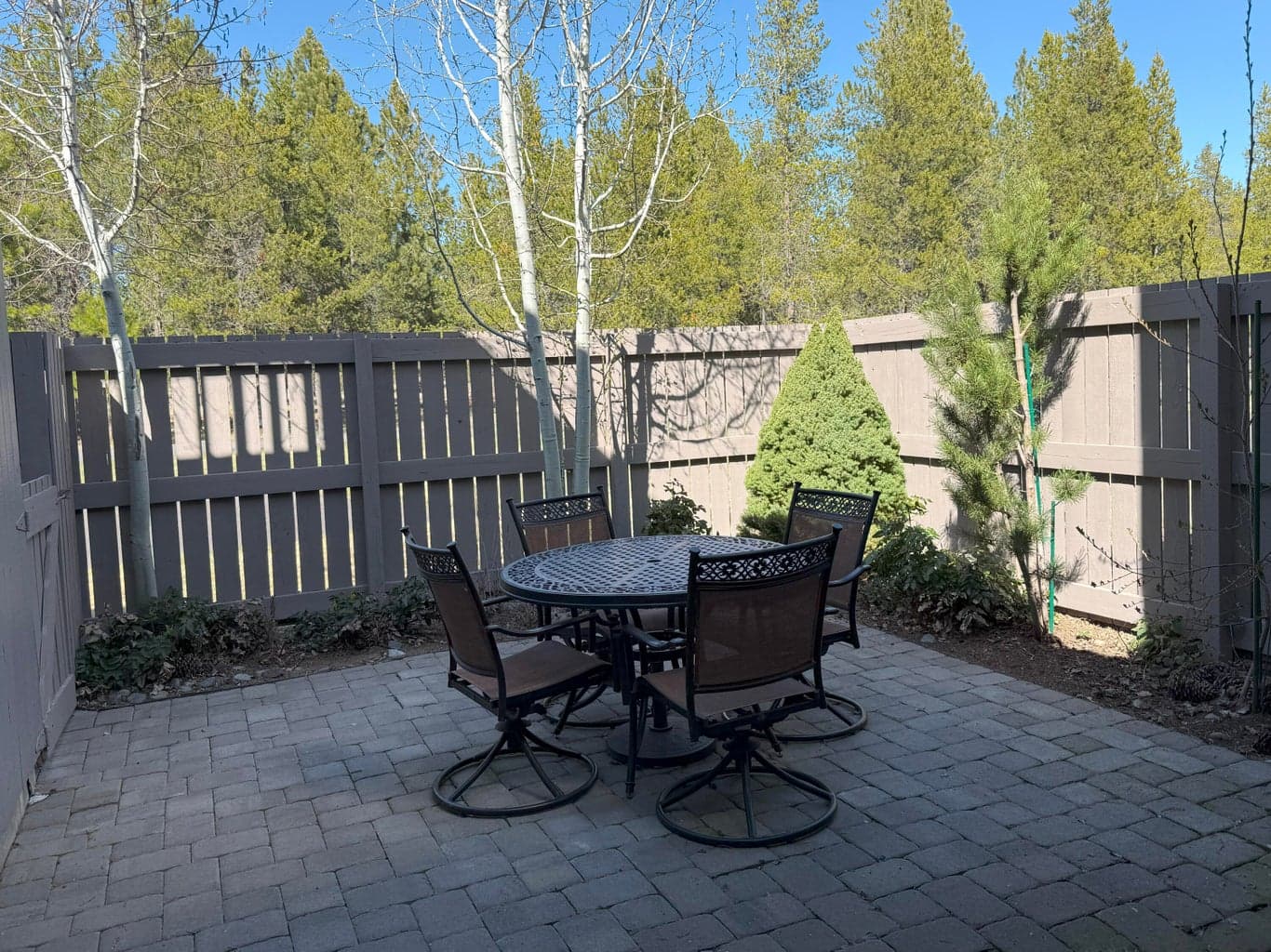 Enjoy two charming outdoor spaces - one overlooking the golf course and another featuring a fully fenced-in paver patio for added privacy.