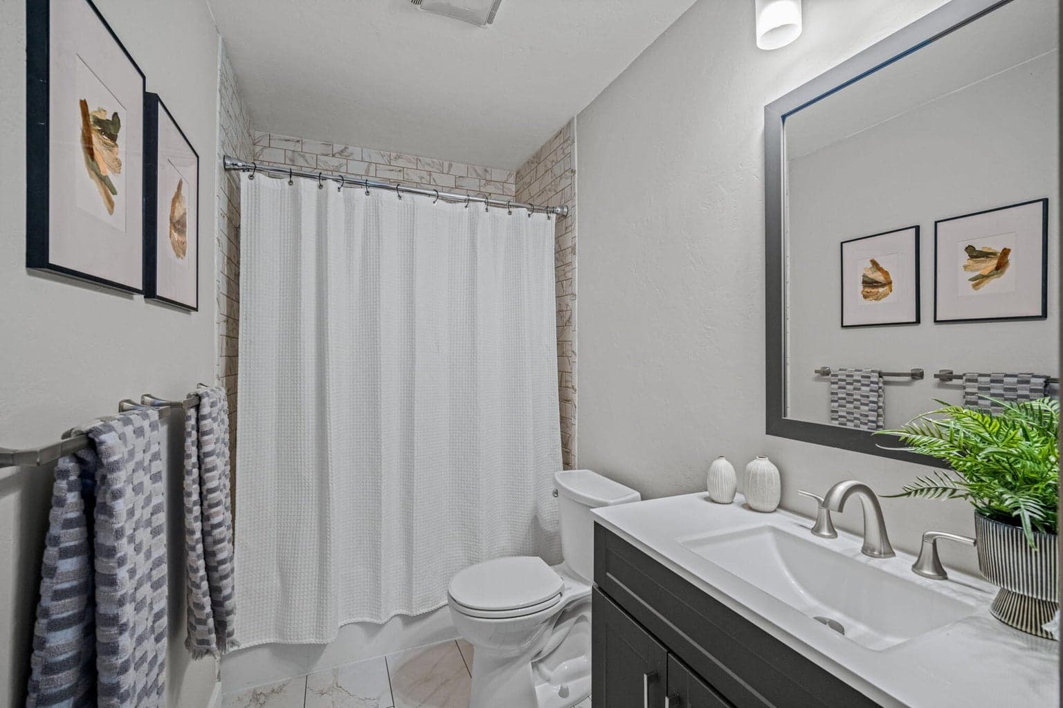 Guest bath beautifully updated with tile shower surround