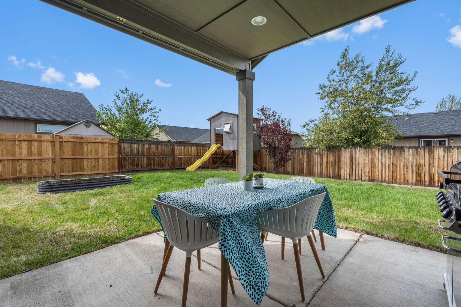 Covered back patio perfect for barbecuing year round!