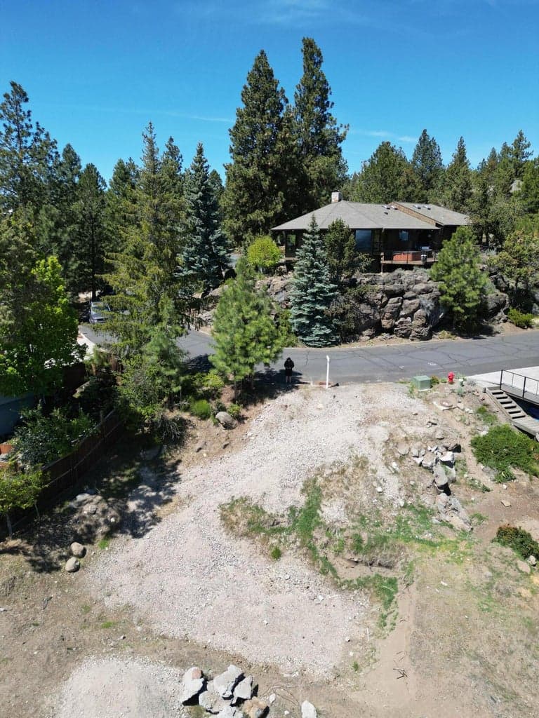 Tucked near the end of a peaceful cul-de-sac, this homesite offers a rare blend of seclusion and convenience—just minutes from the vibrant shops and restaurants of Newport Avenue and Northwest Crossing. Enjoy nearly 180-degree southeast views that capture brilliant sunrises, glowing winter sunsets, and twinkling city lights by night. The property is thoughtfully positioned to shelter you from prevailing winds and intense afternoon sun, offering a comfortable, year-round outdoor experience. Surrounded by natural beauty, it’s the perfect canvas to create a home that embraces both tranquility and connection to Bend’s best amenities.